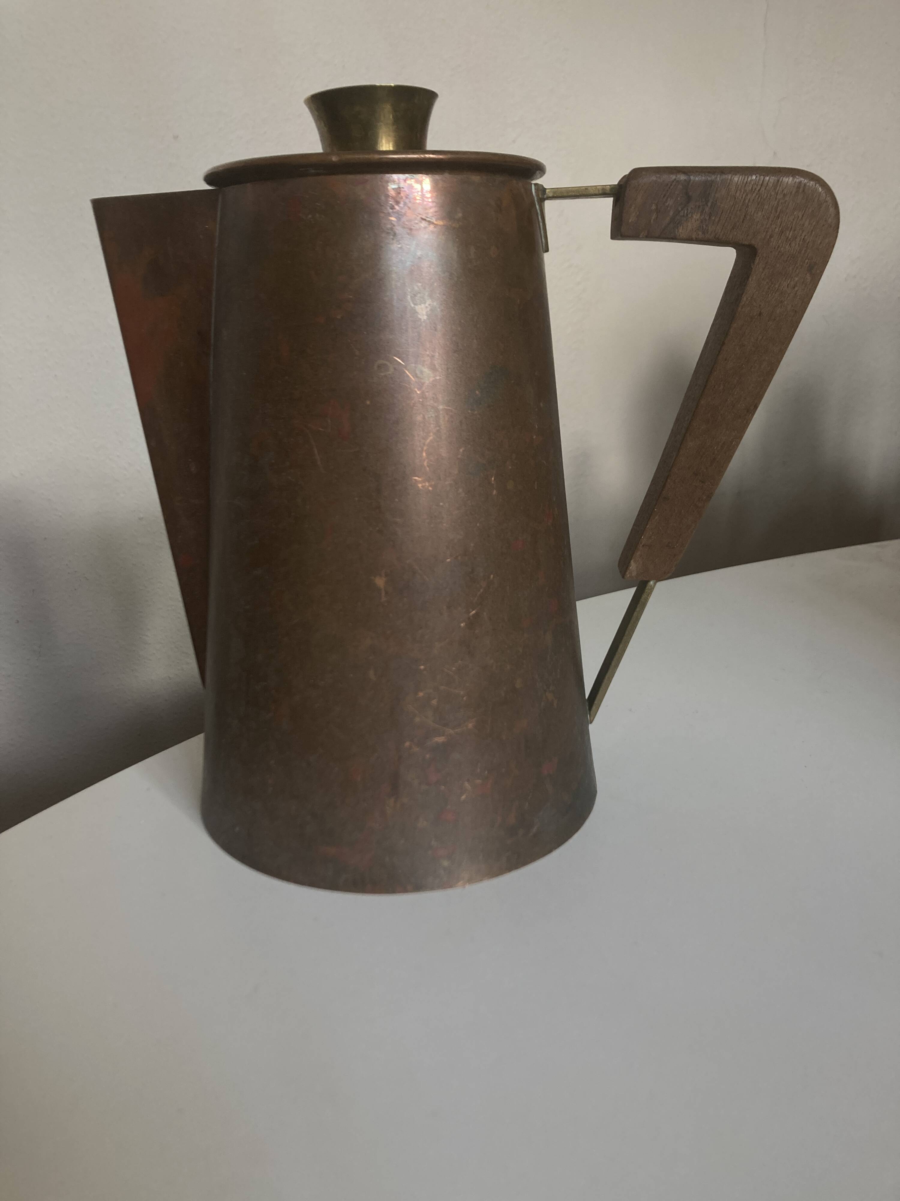 Modernist Italian pitcher design from the 1960s in patinated wood and metal.