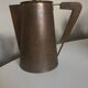 Modernist Italian pitcher design from the 1960s in patinated wood and metal.