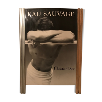 Vintage poster on advertising board Eau Sauvage Christian Dior