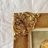 Old wall frame in carved gilded wood