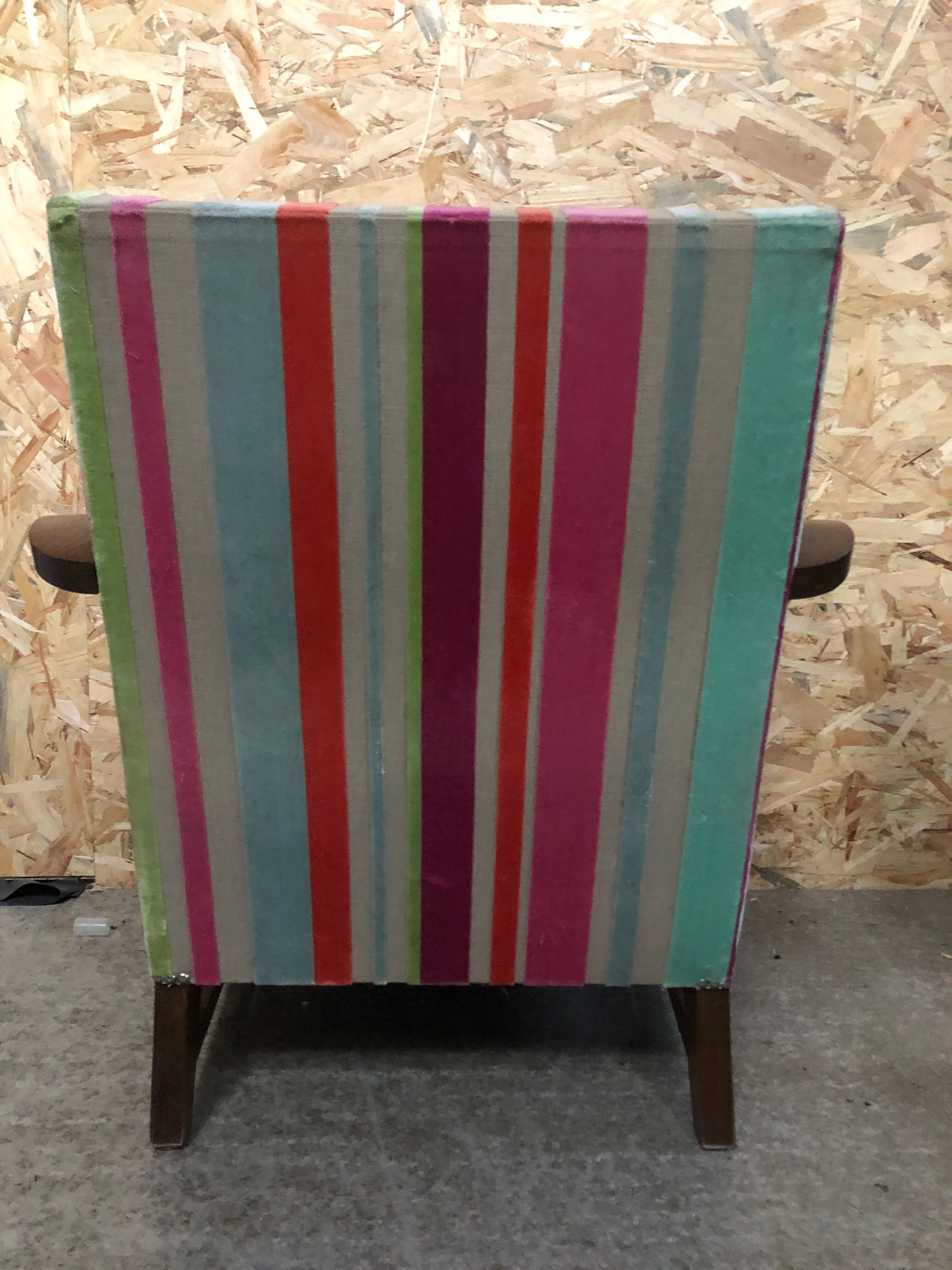 Old wooden armchair with curved armrests