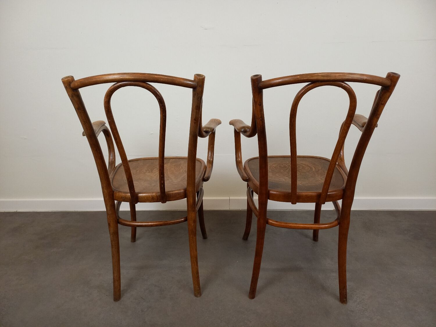 Pair of curved wooden bistro armchairs