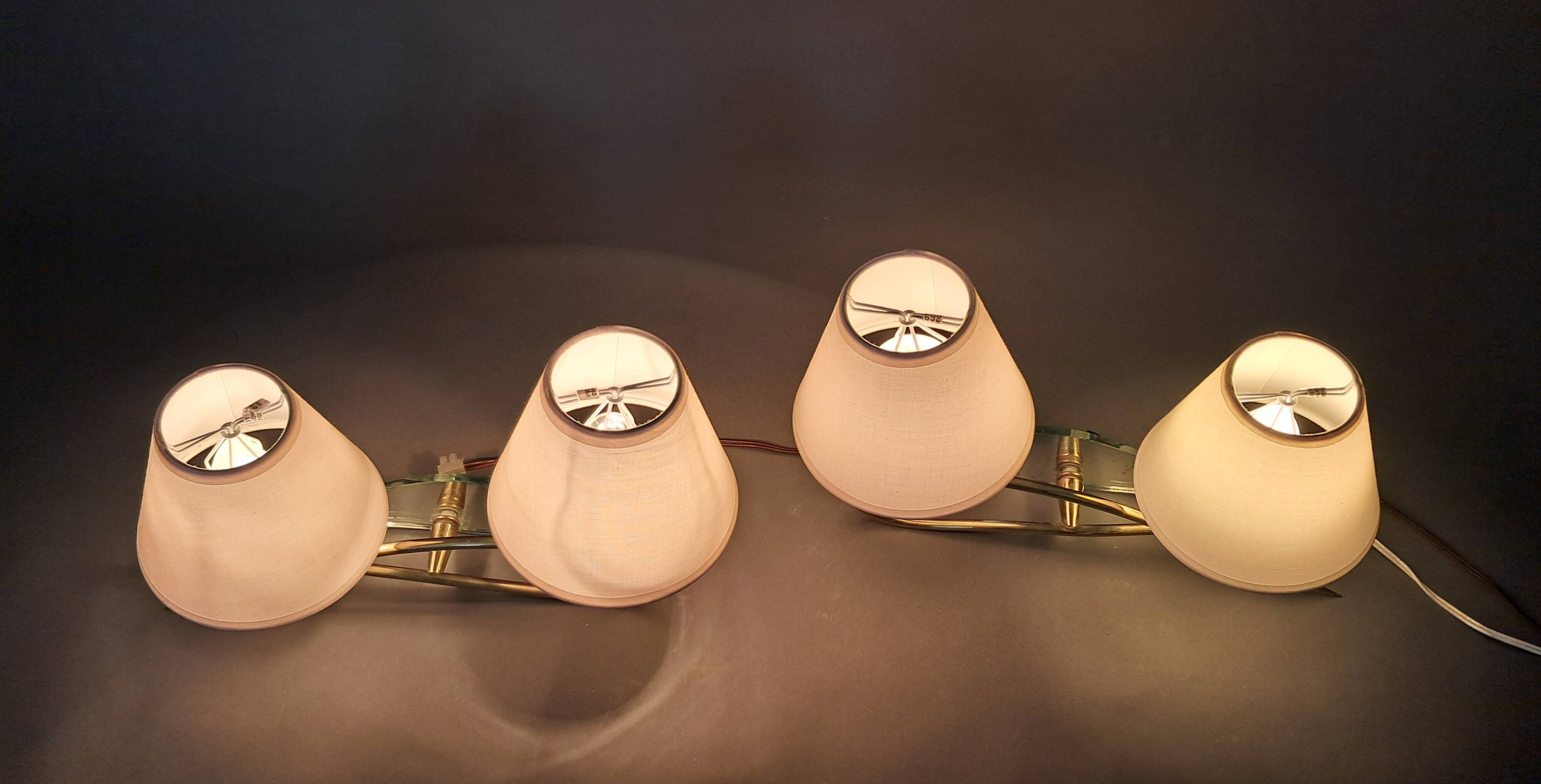 Pair of gilded brass and mirror wall lights, Circa 1960.