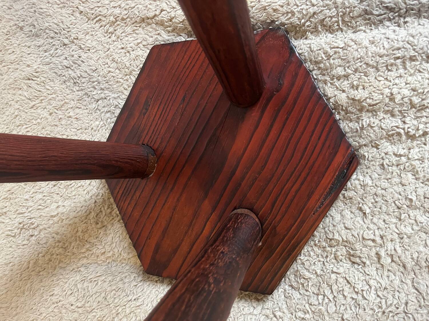 Wooden tripod stool in mountain chalet style