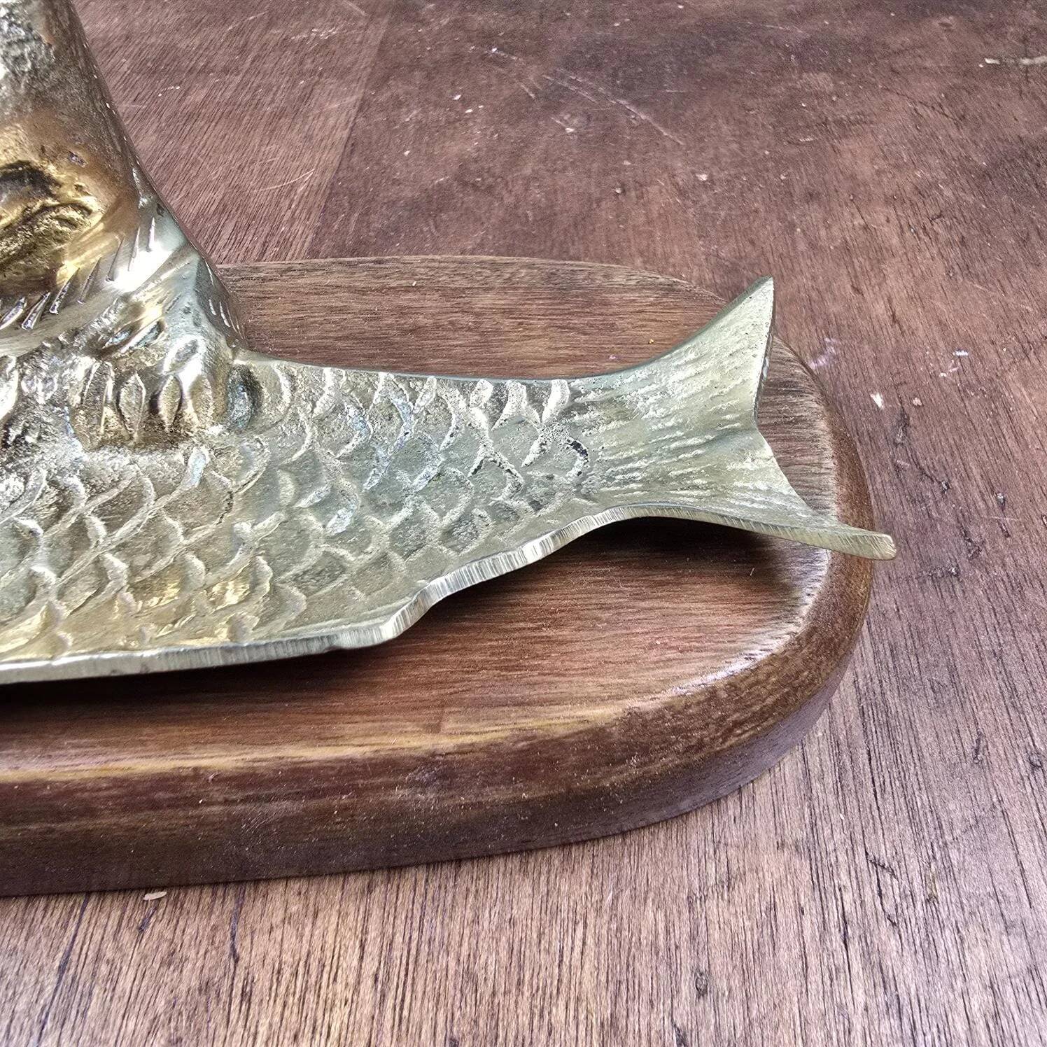 Vintage cat fish catchall in brass on a solid wood base.