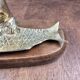 Vintage cat fish catchall in brass on a solid wood base.