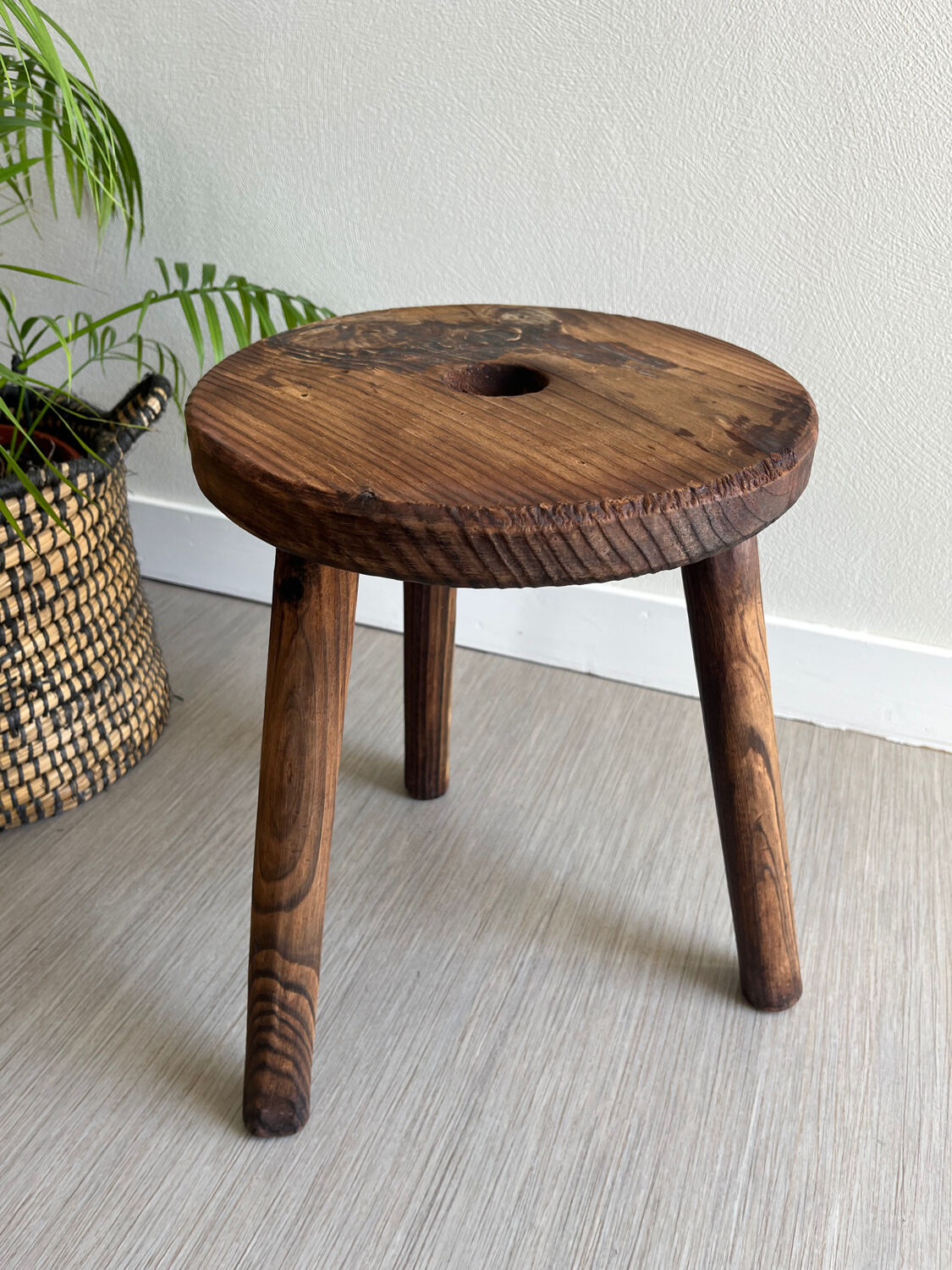 Three-legged wooden stool