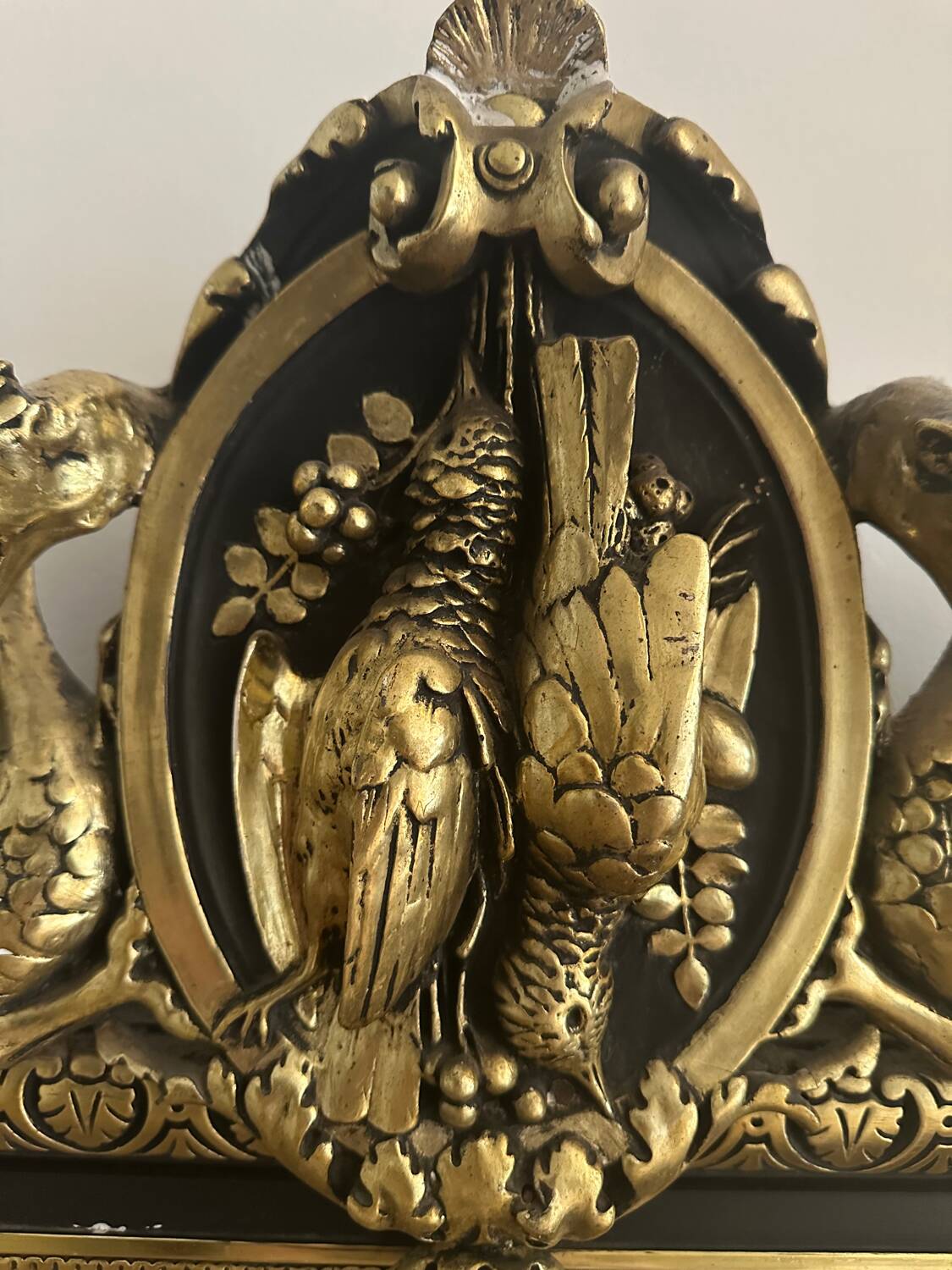 Napoleon III mirror with a pediment featuring black and gold dragons and birds.