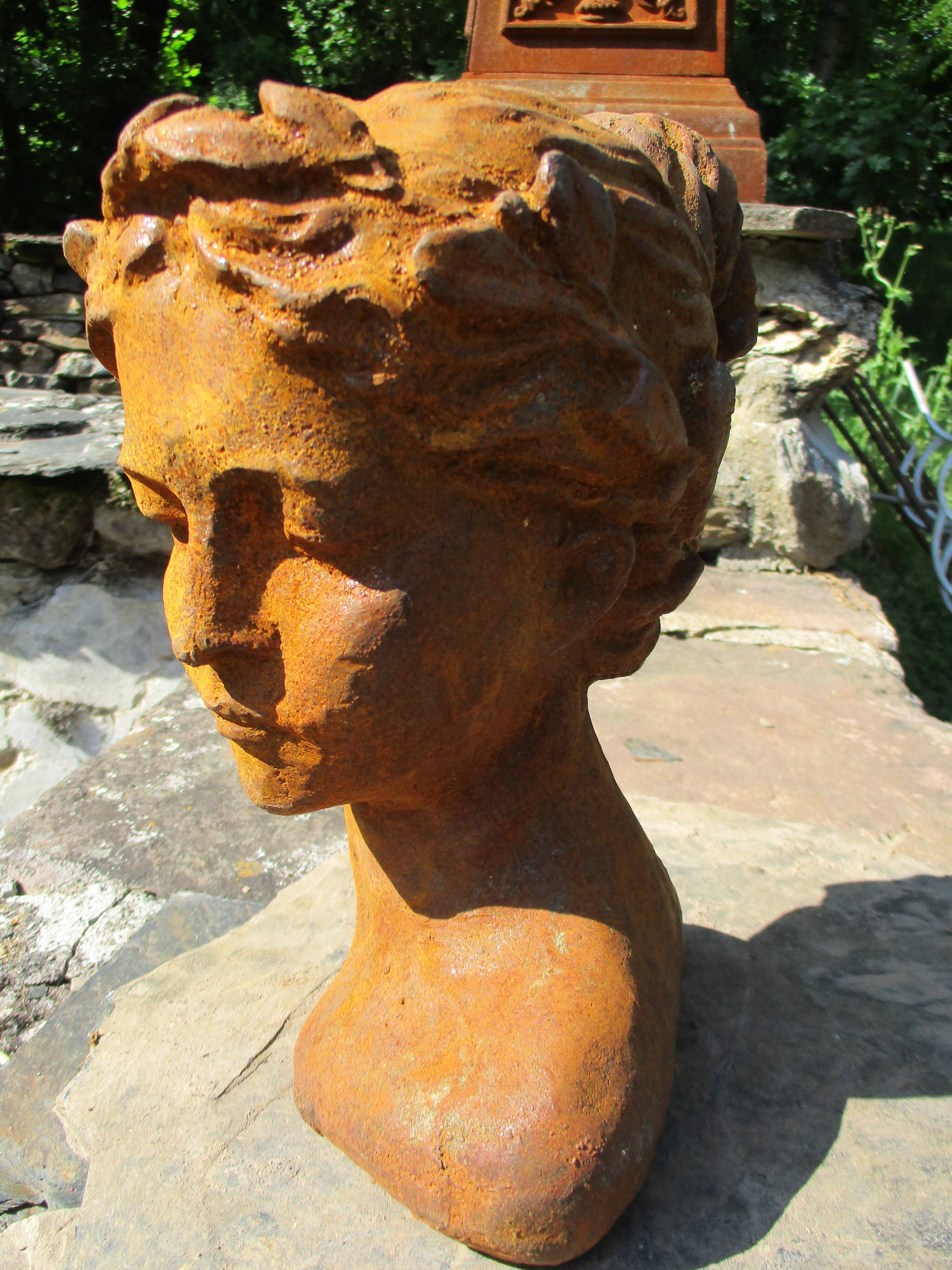Cast iron sculpture of a woman.