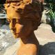 Cast iron sculpture of a woman.