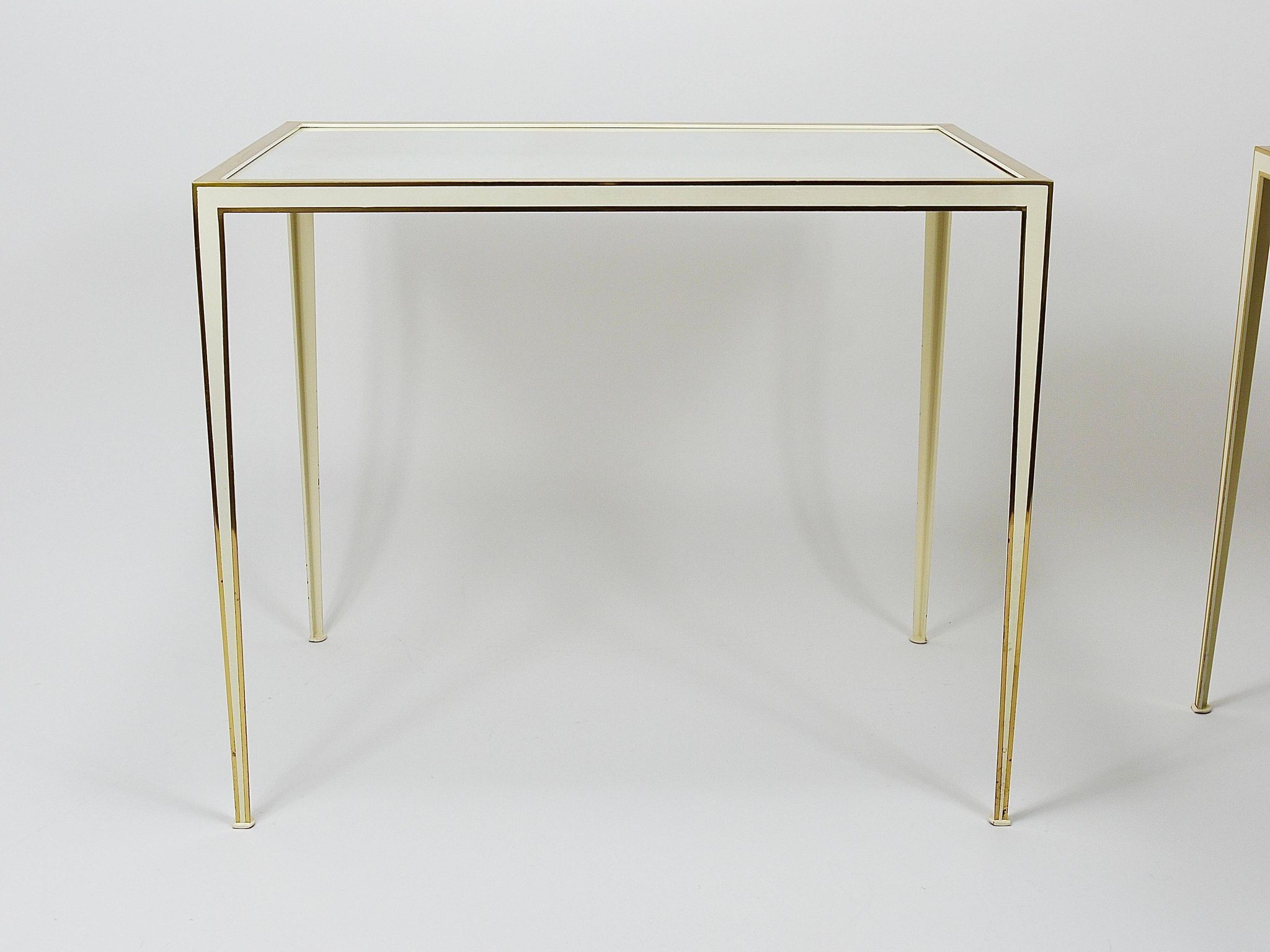 A pair of brass and white mirror tables from Vereinigte Werkstätten, Germany, 1970s.
