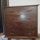 Vintage chest of drawers from the 1950s with wooden legs and a design feature.