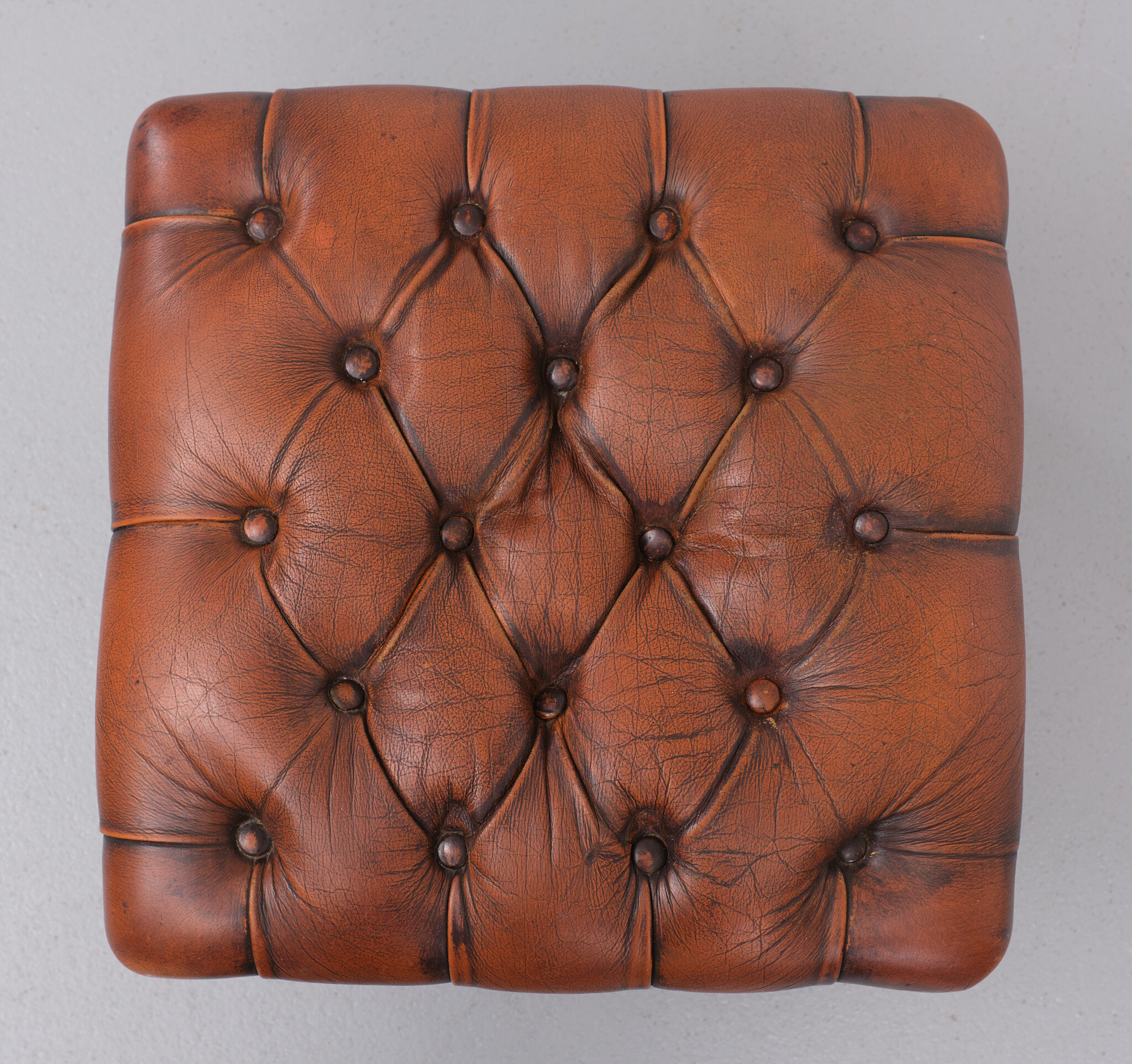 English country house style padded leather ottoman