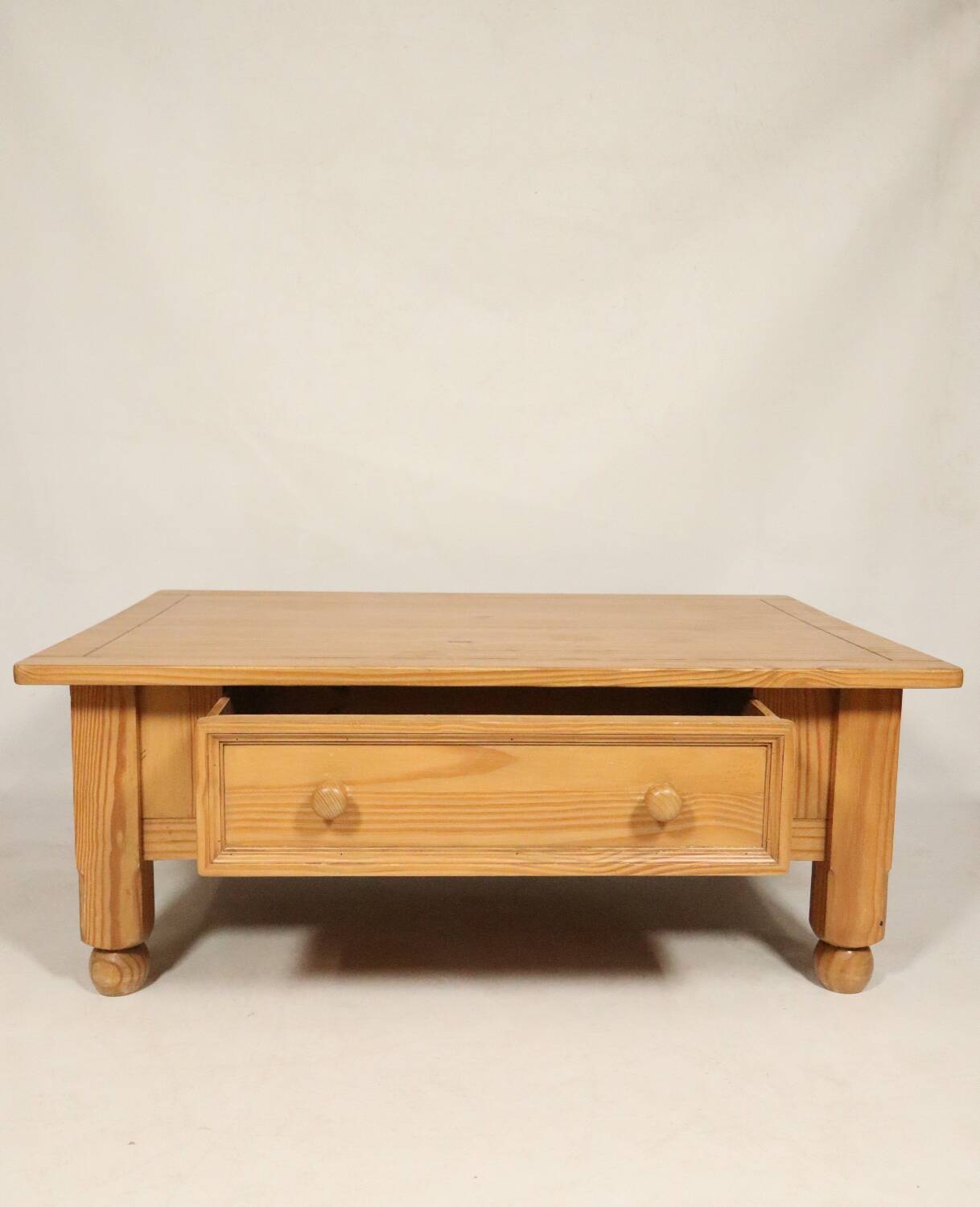 Rustic vintage style coffee table in light wood, mid-century modern design.