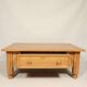 Rustic vintage style coffee table in light wood, mid-century modern design.