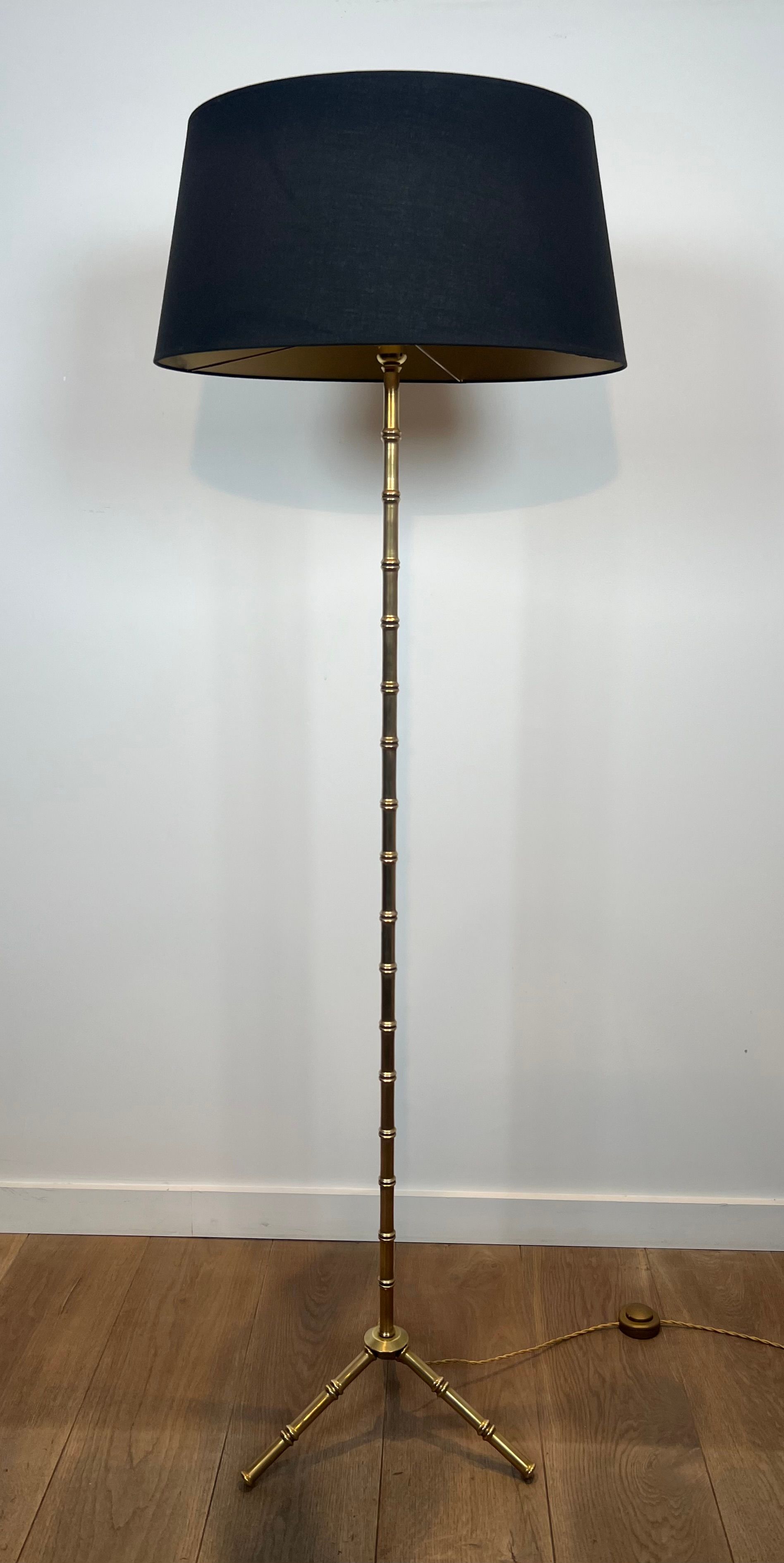 Pair of parquet floor lamps in faux-bamboo style in bronze and brass by Jacques Adnet.
