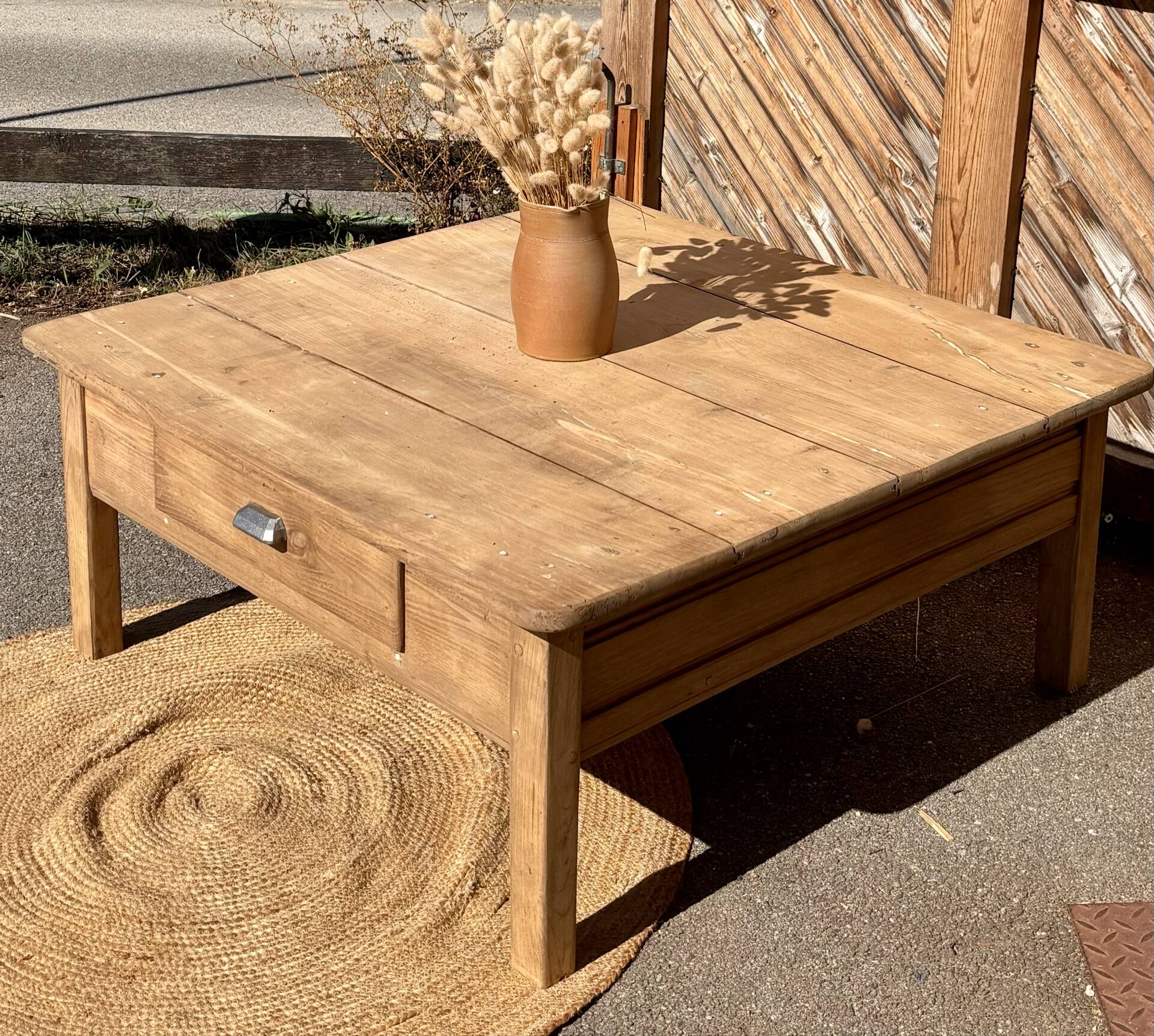 Large square farmhouse coffee table made of raw solid oak.