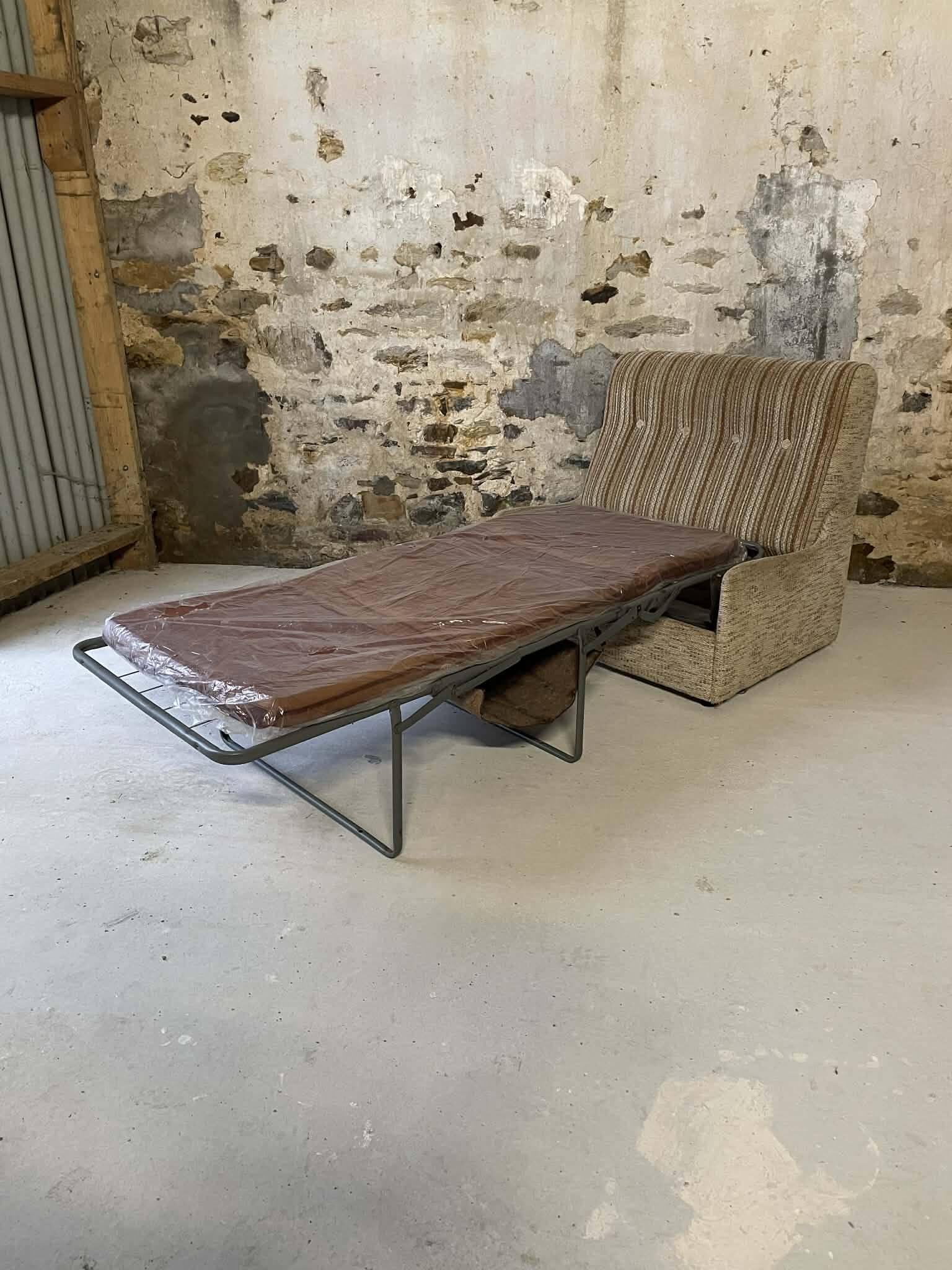 Vintage convertible armchair into a guest bed.