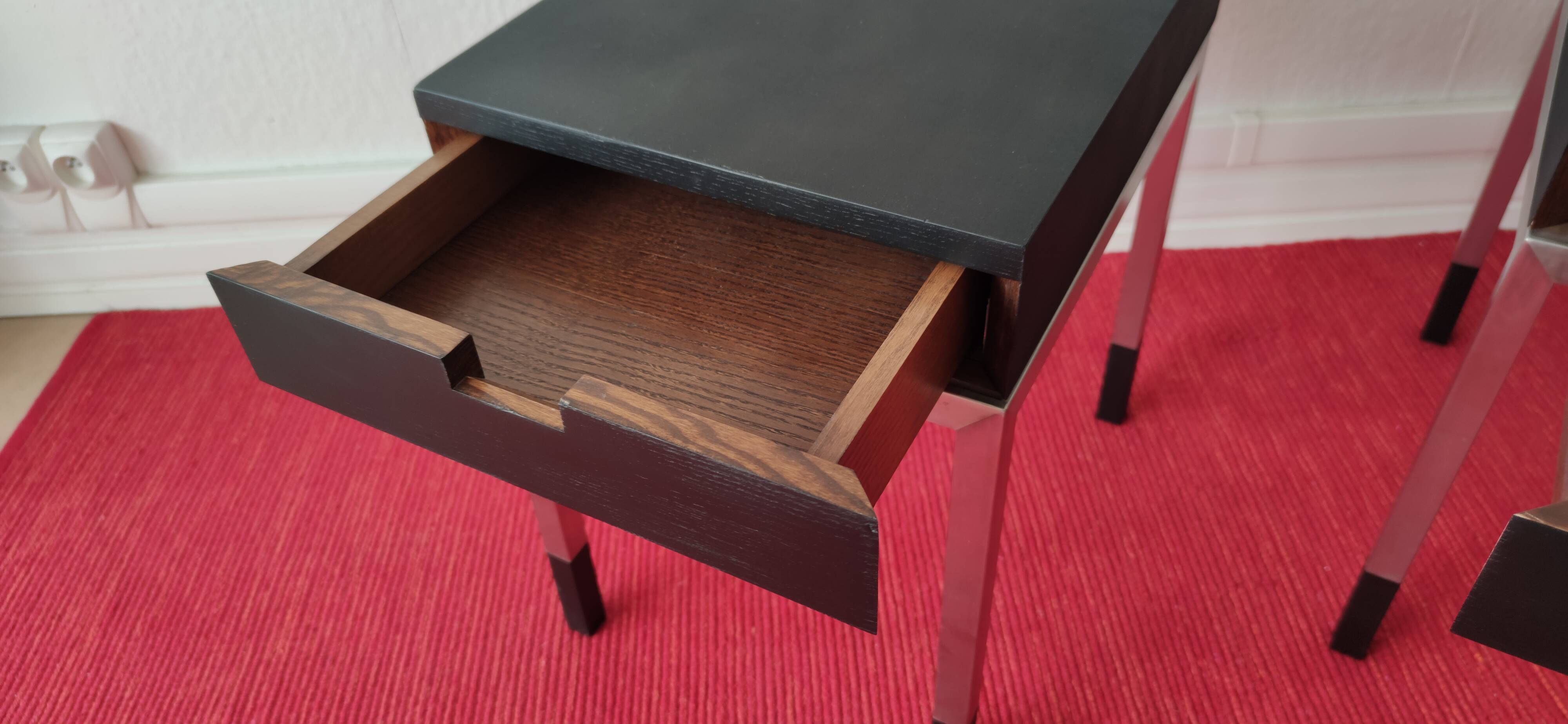 A pair of minimalist bedside tables