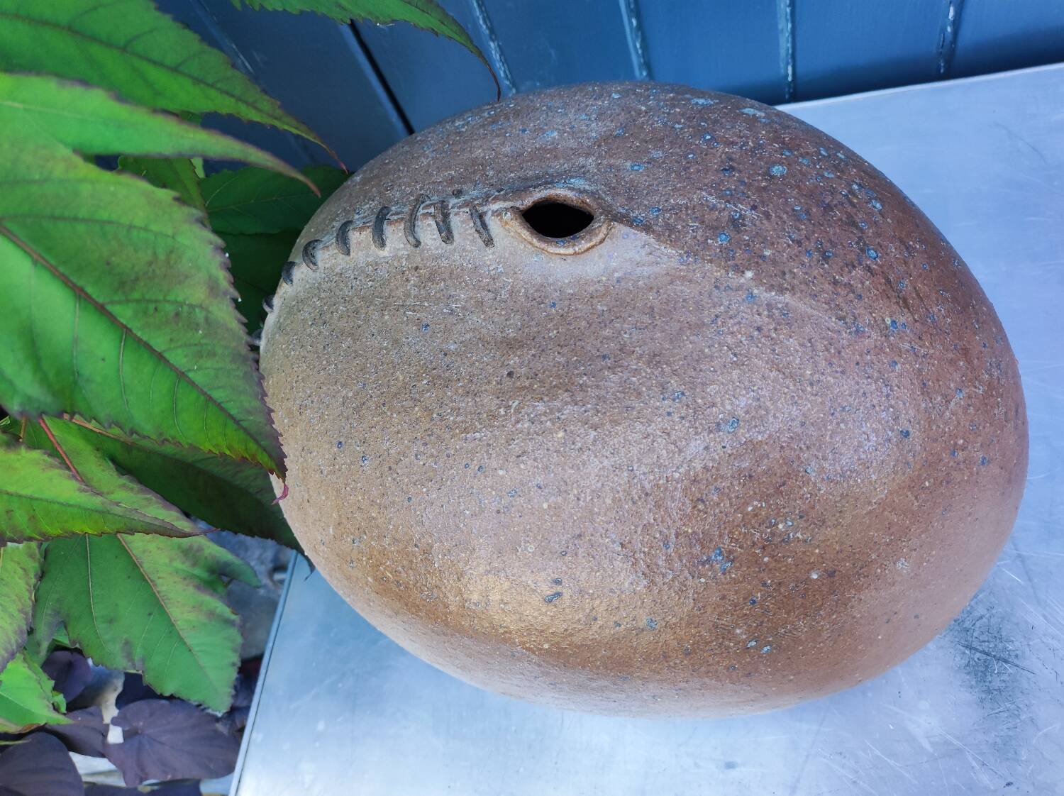 Vintage sandstone vase, in the shape of a rugby ball, signed