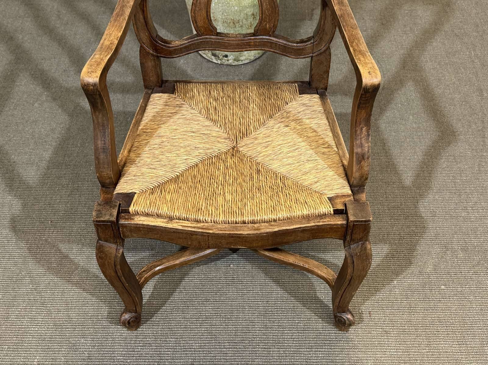 20th-century armchair in beech with a straw seat in Louis XV style.