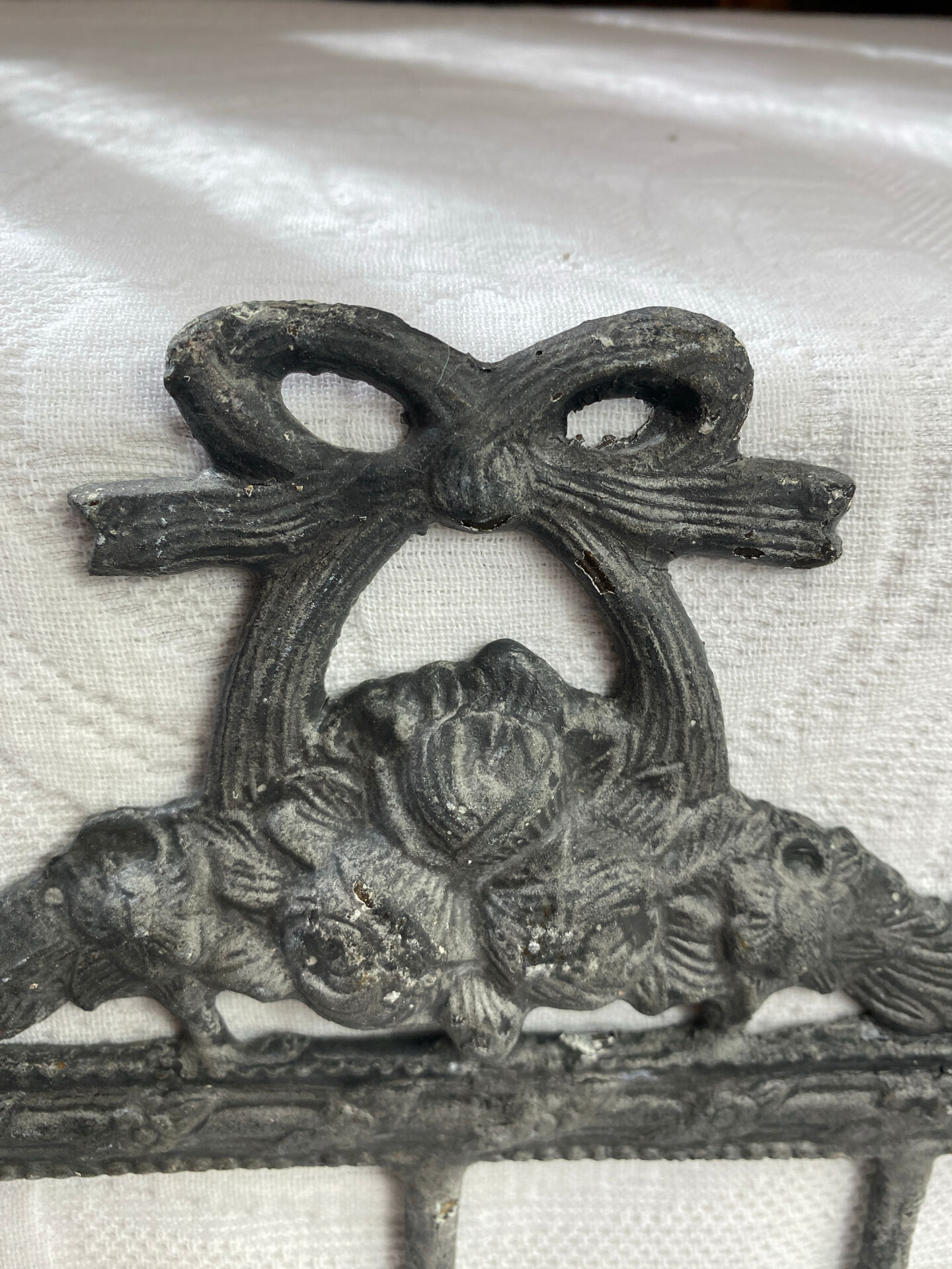 Patinated metal wall bracket and porcelain