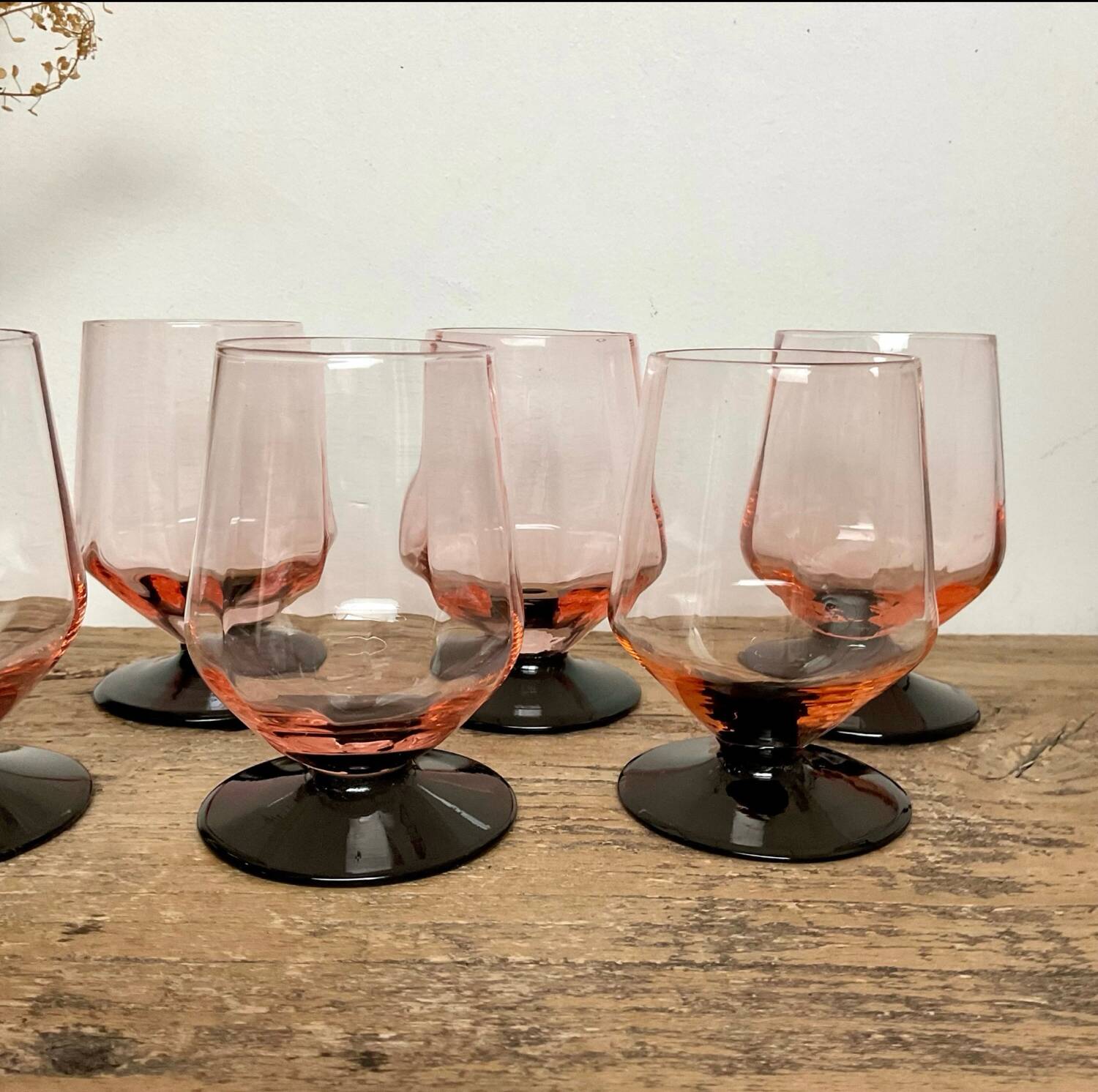 6 small pink glasses with black stems