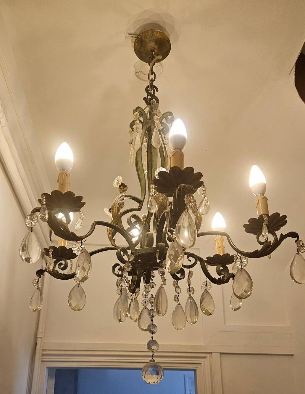 Antique wrought iron chandelier with 6 lights and pendants.