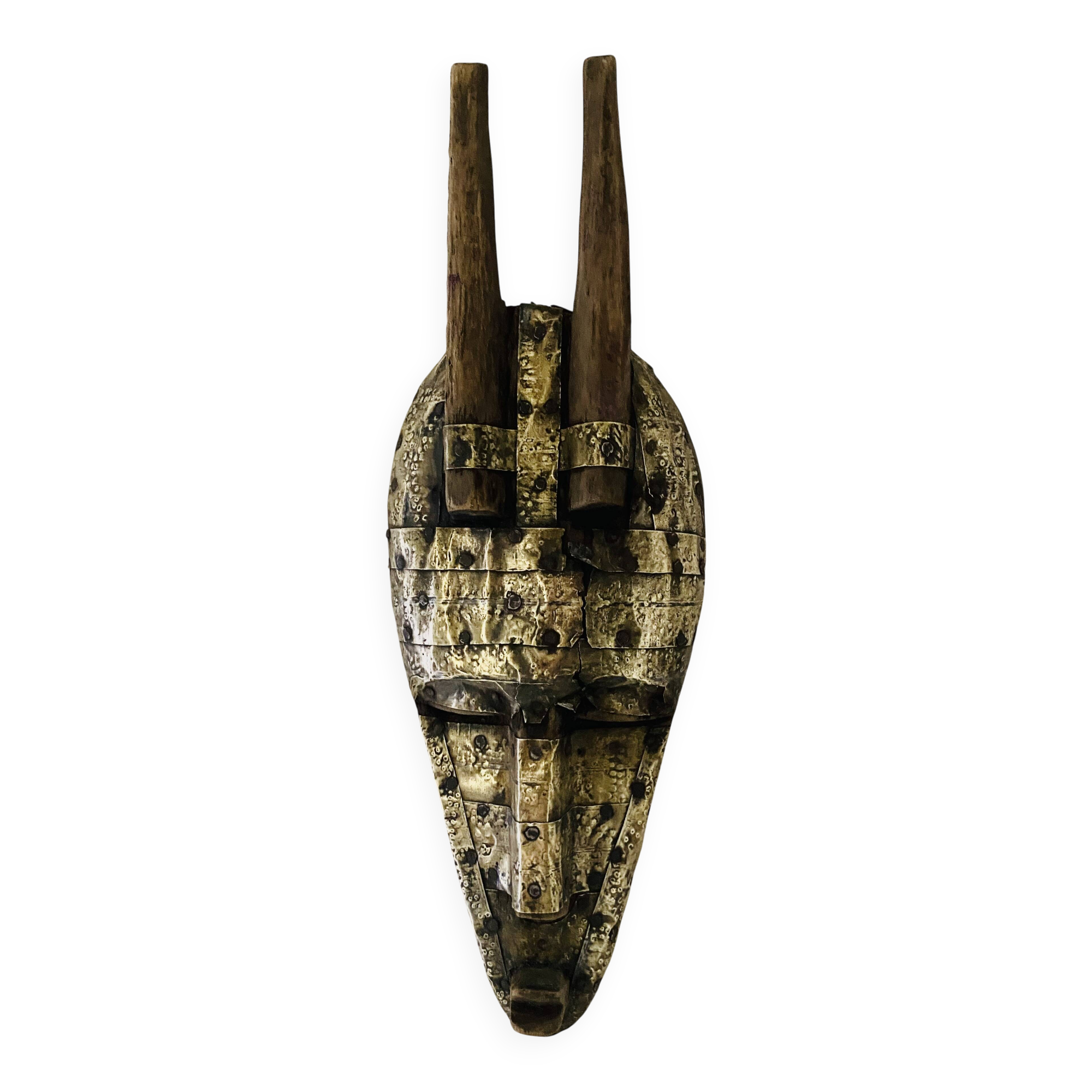 Ancient wooden and brass mask