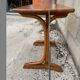 Small side table or bistro serving table with curved wood.