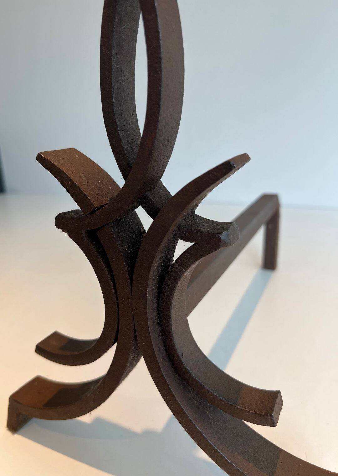 Pair of Wrought Iron Andirons with Stylised Flamboyant Uprights and Enrobed Feet