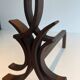 Pair of Wrought Iron Andirons with Stylised Flamboyant Uprights and Enrobed Feet