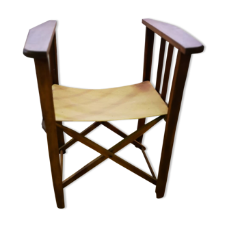 Vintage wooden folding chair with beige canvas seat