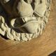 Off-white plaster lion head relief on natural wood panel — Walter De Buck, classical decorative sculpture
