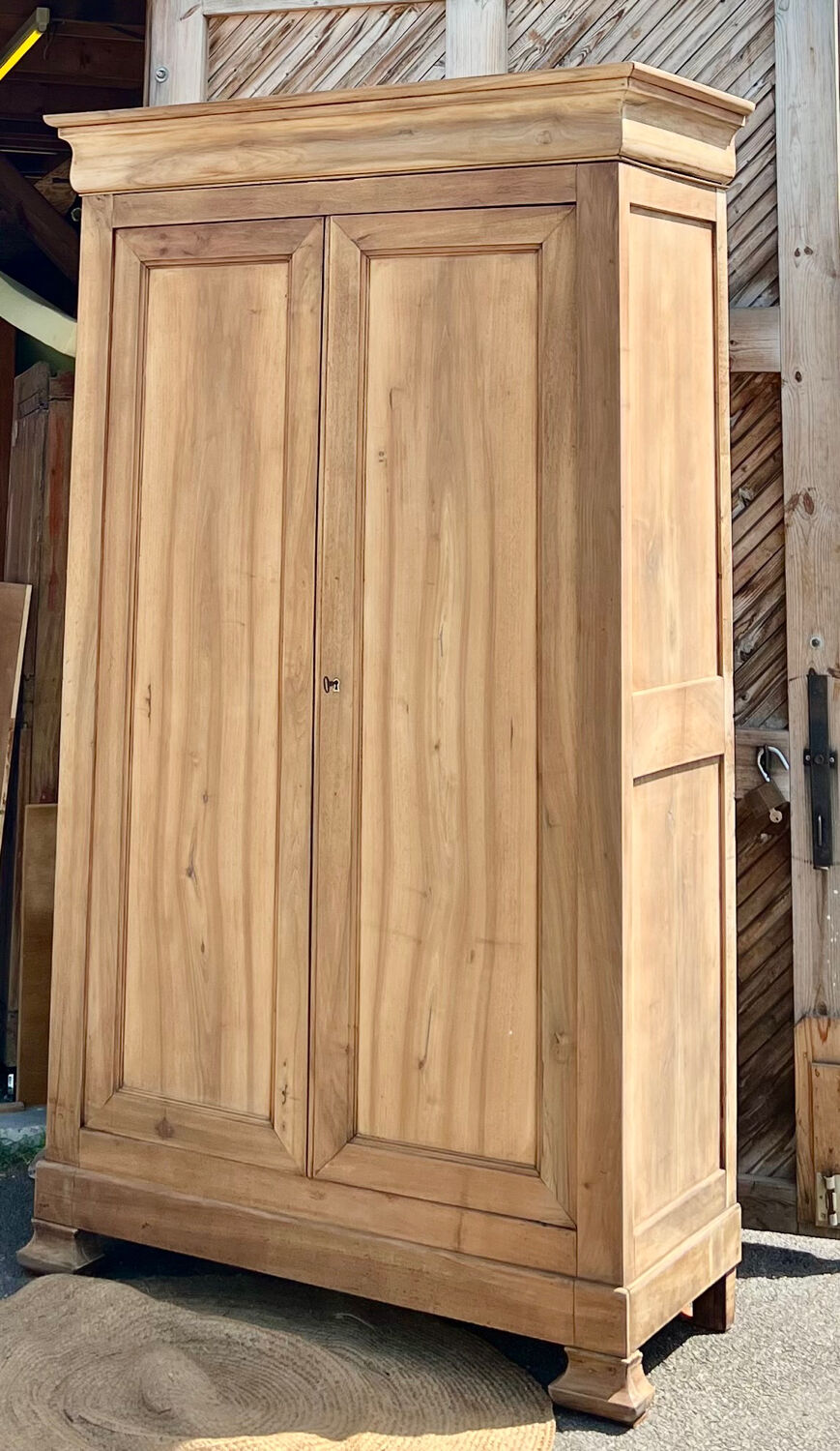 Large antique wardrobe in raw solid wood, chic country style.