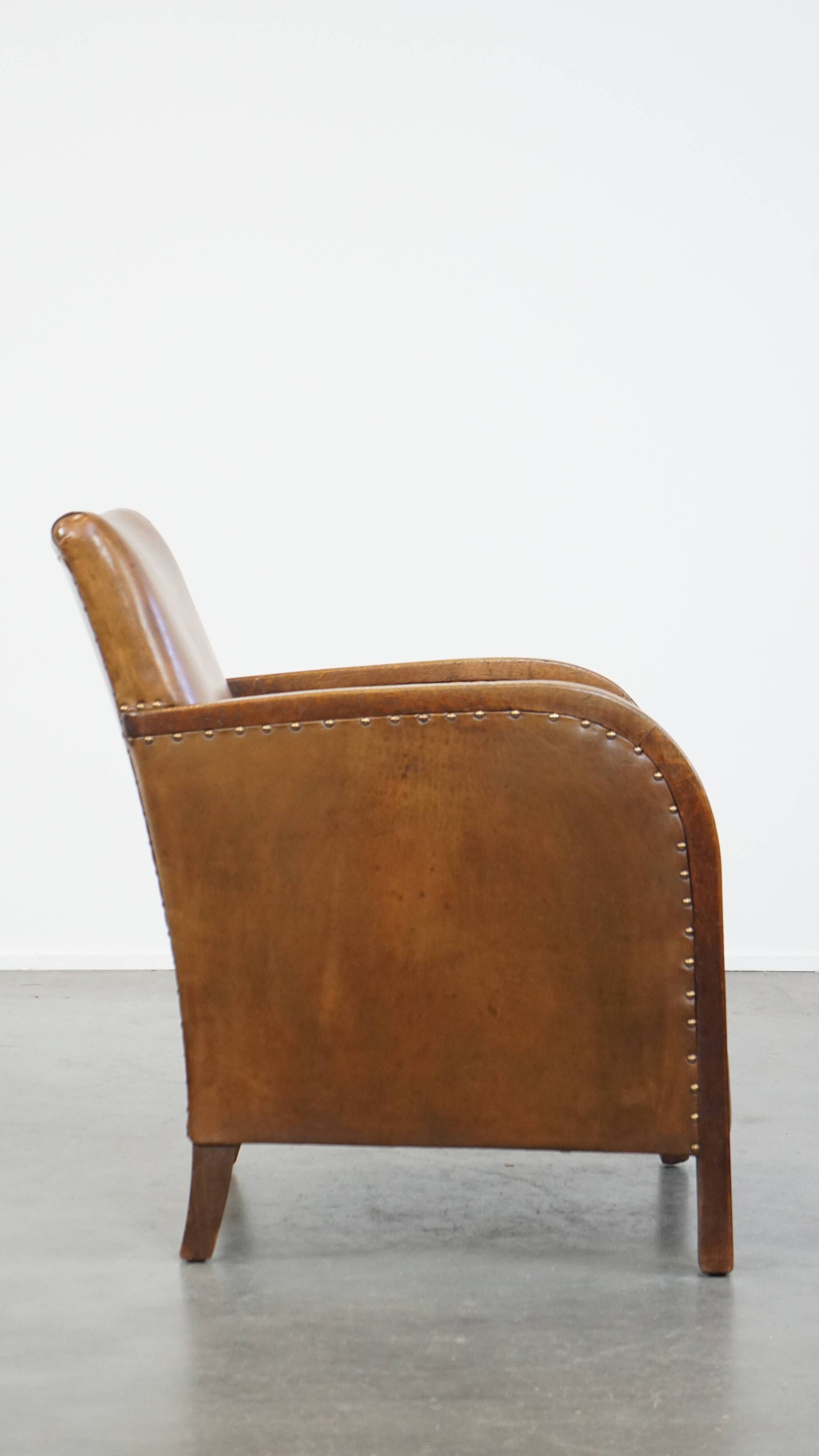 Cognac-colored sheepskin and wooden Art Deco design armchair