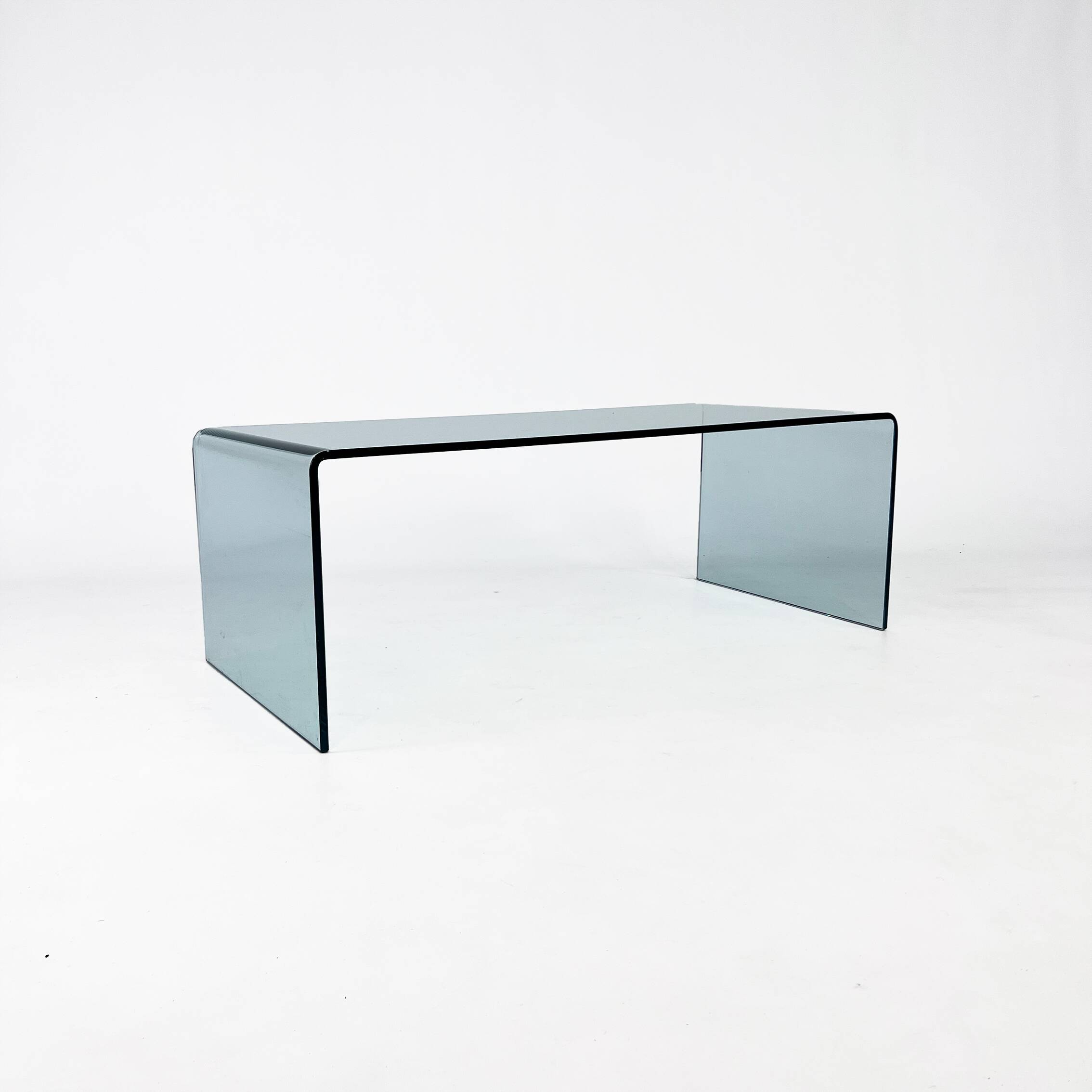 Postmodern coffee table made entirely of glass. Modernist and bitches minimalist look.