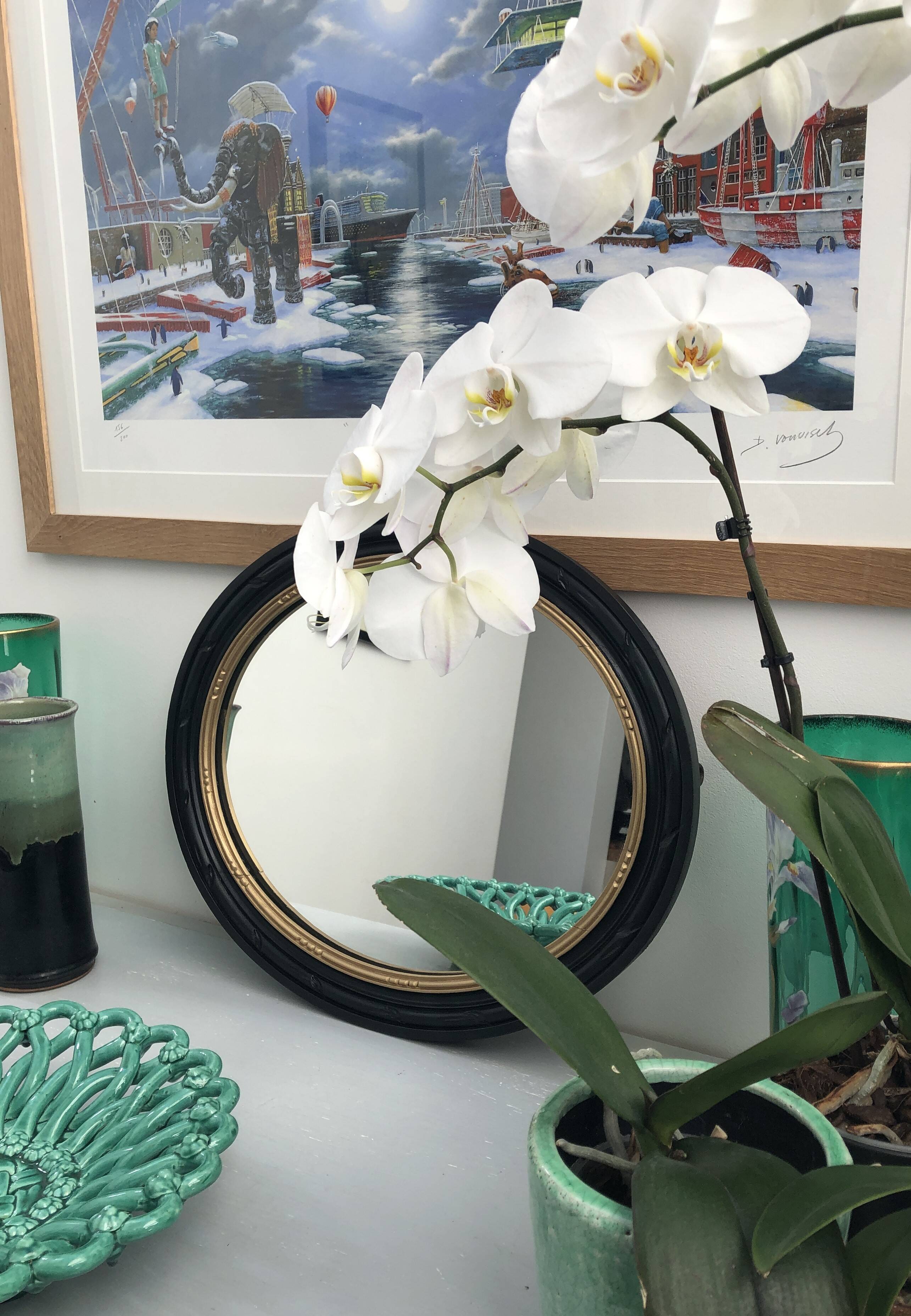 black and gold oval mirror