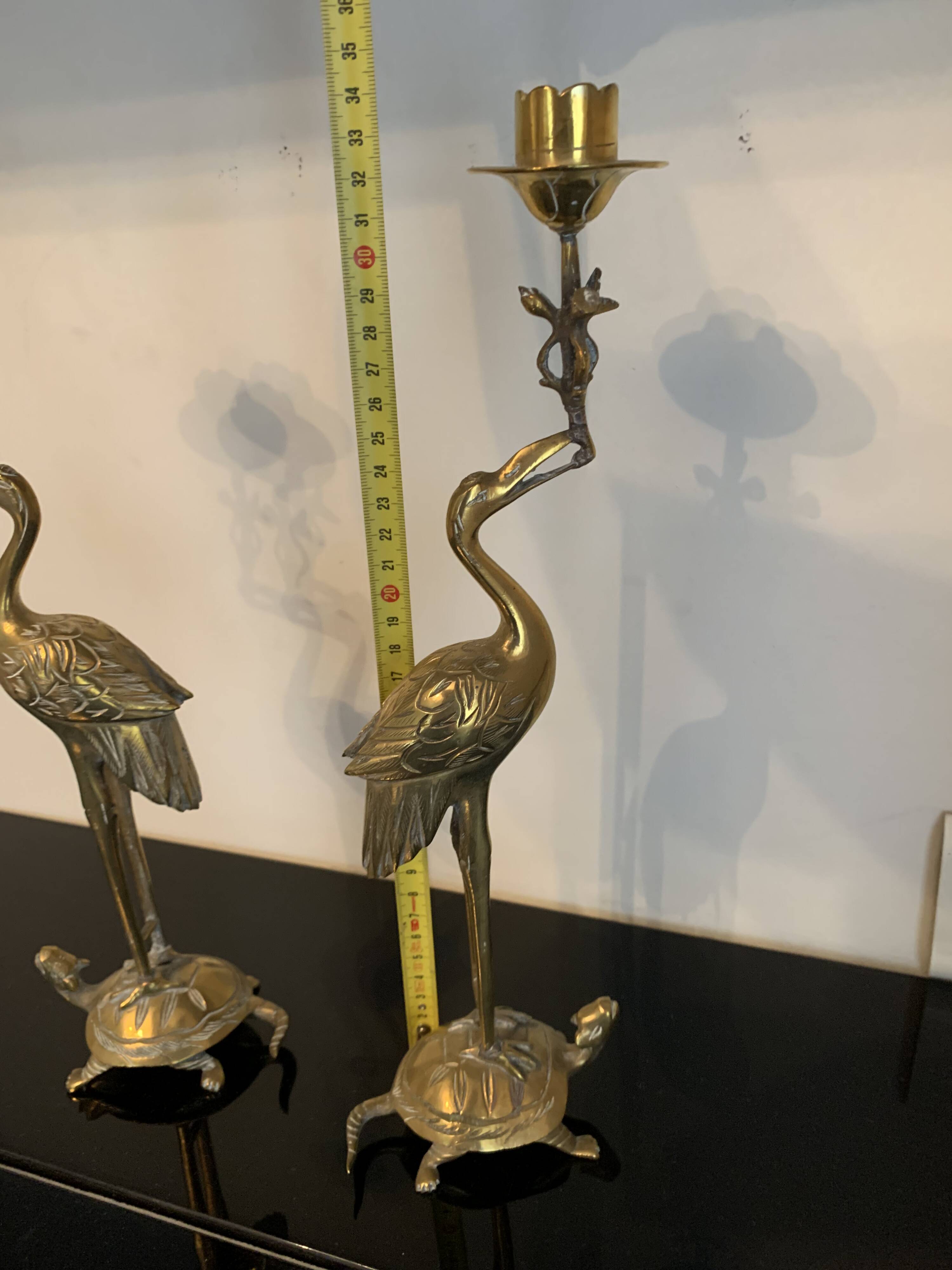 Pair of chiseled and gilded bronze candlesticks depicting perched waders