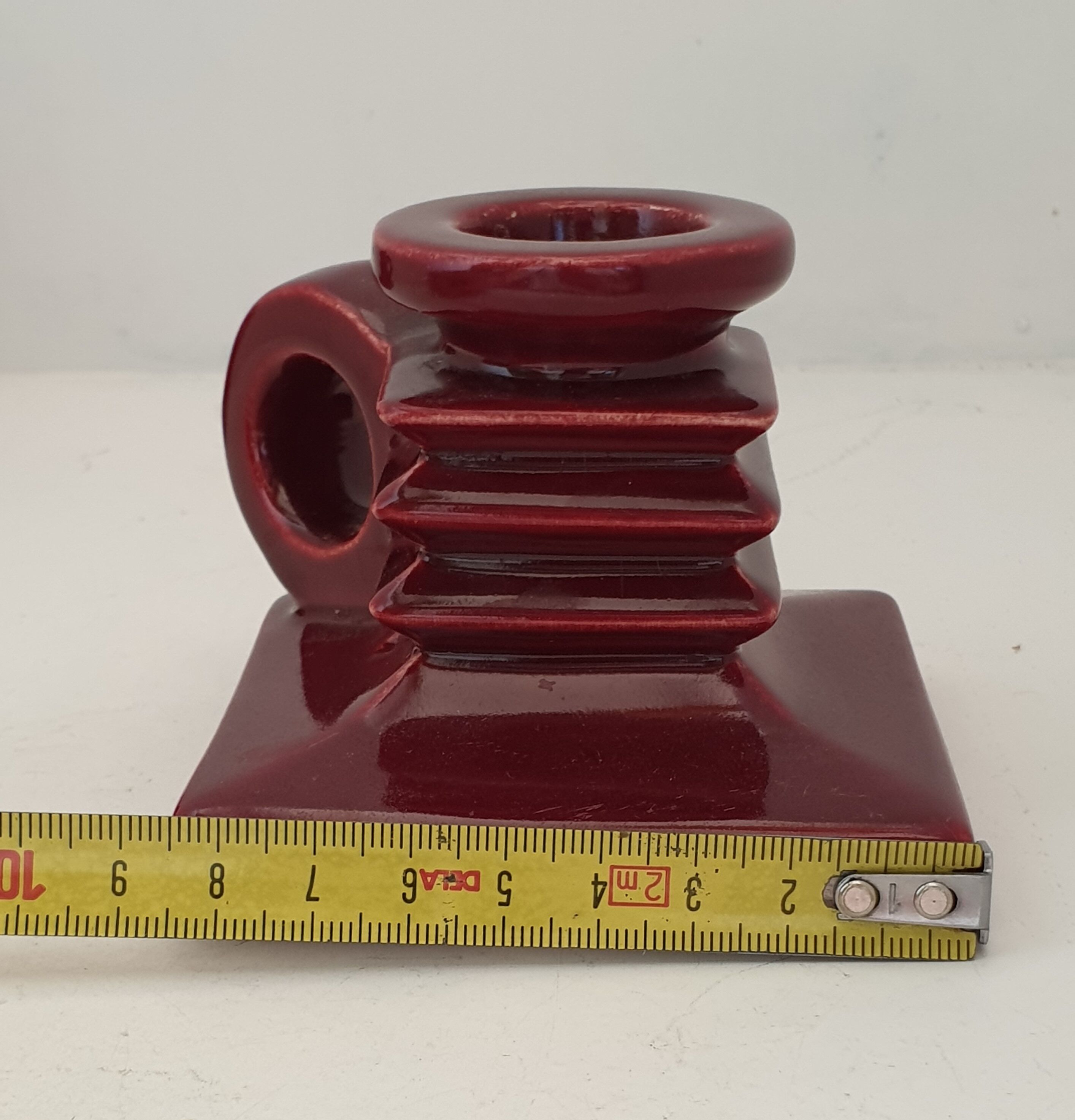 Pair of art deco candlesticks in bordeaux ceramics