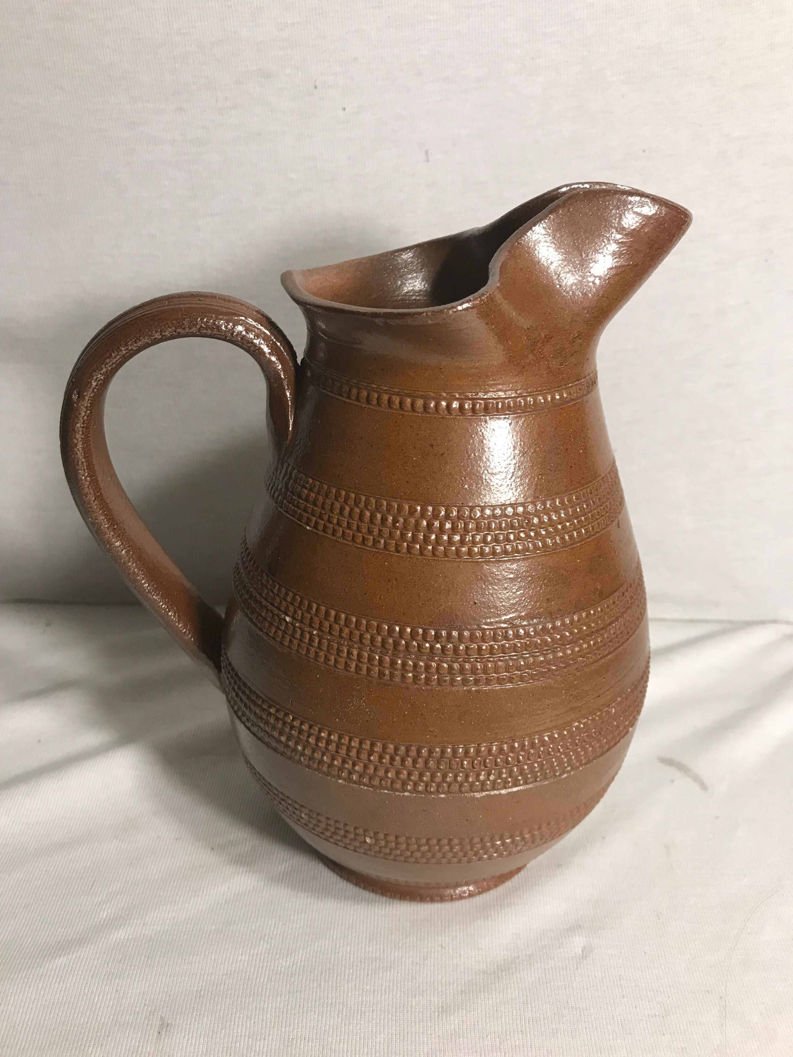 Old brown glazed ceramic jug from the 1950s