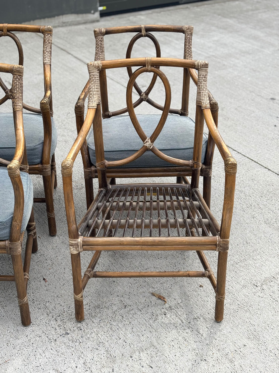 Set of 4 vintage McGuire rattan chairs with cushions.