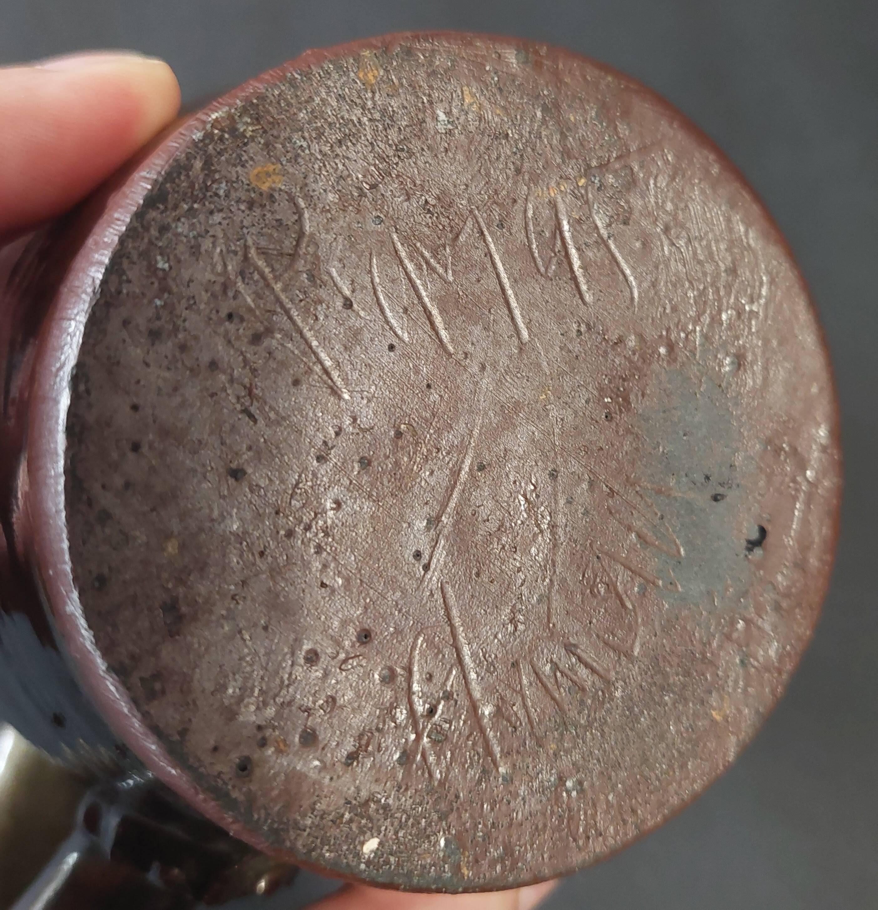 Ceramic pitcher from the 20th century with a signature to identify.