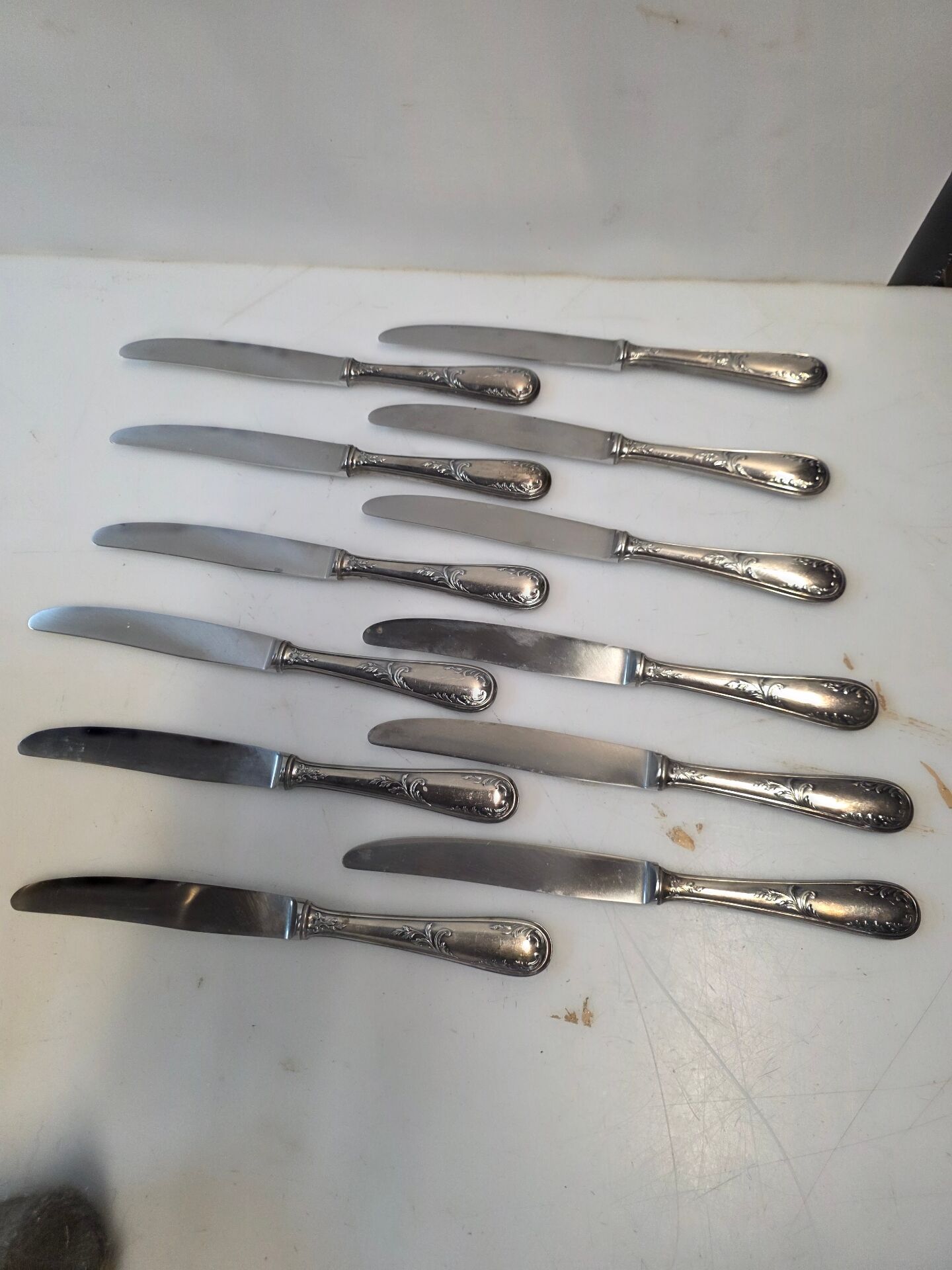 12 silver-plated metal knives from the mid-20th century