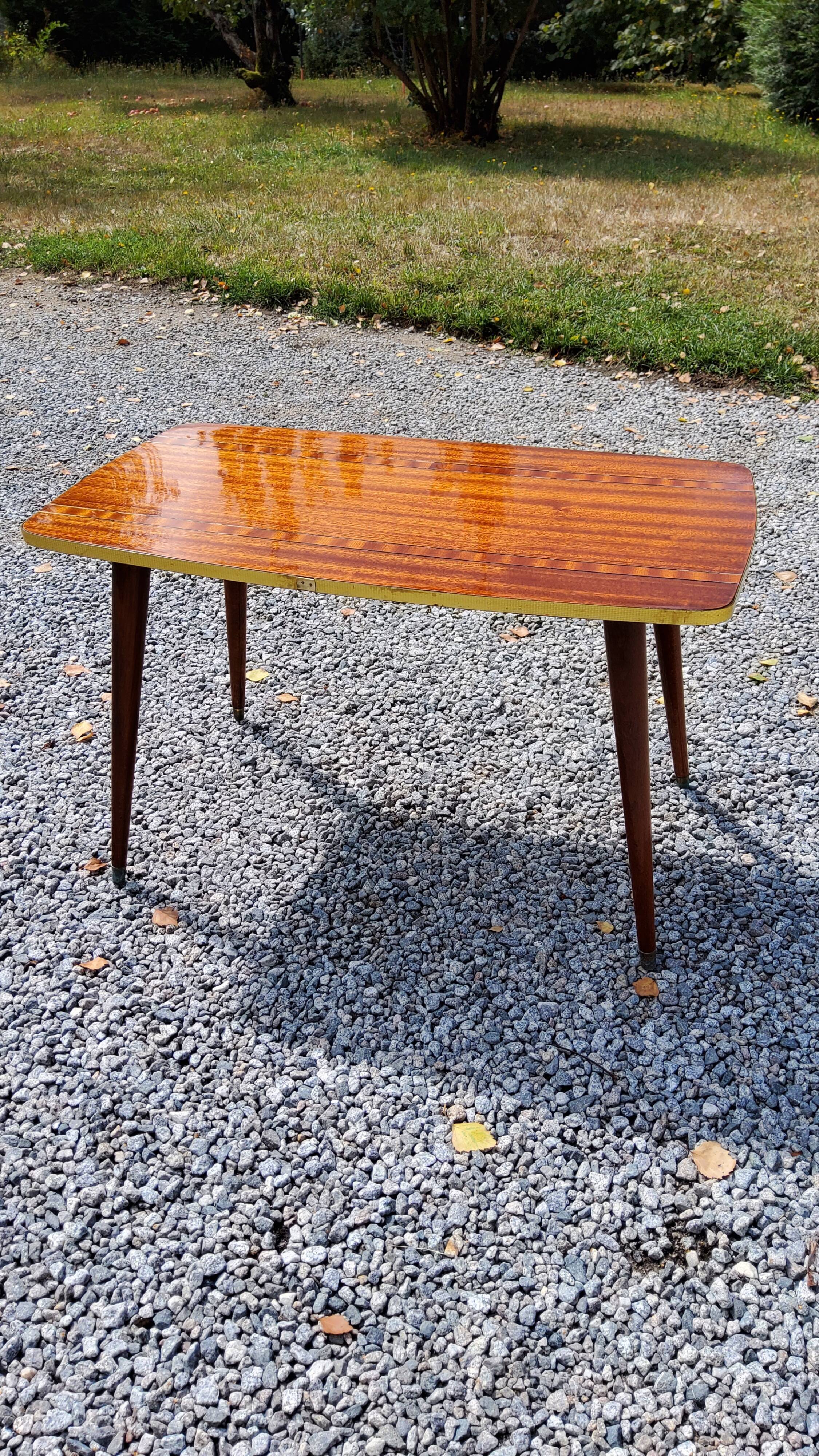 Table basse des années 60 en acajou doré pieds compas