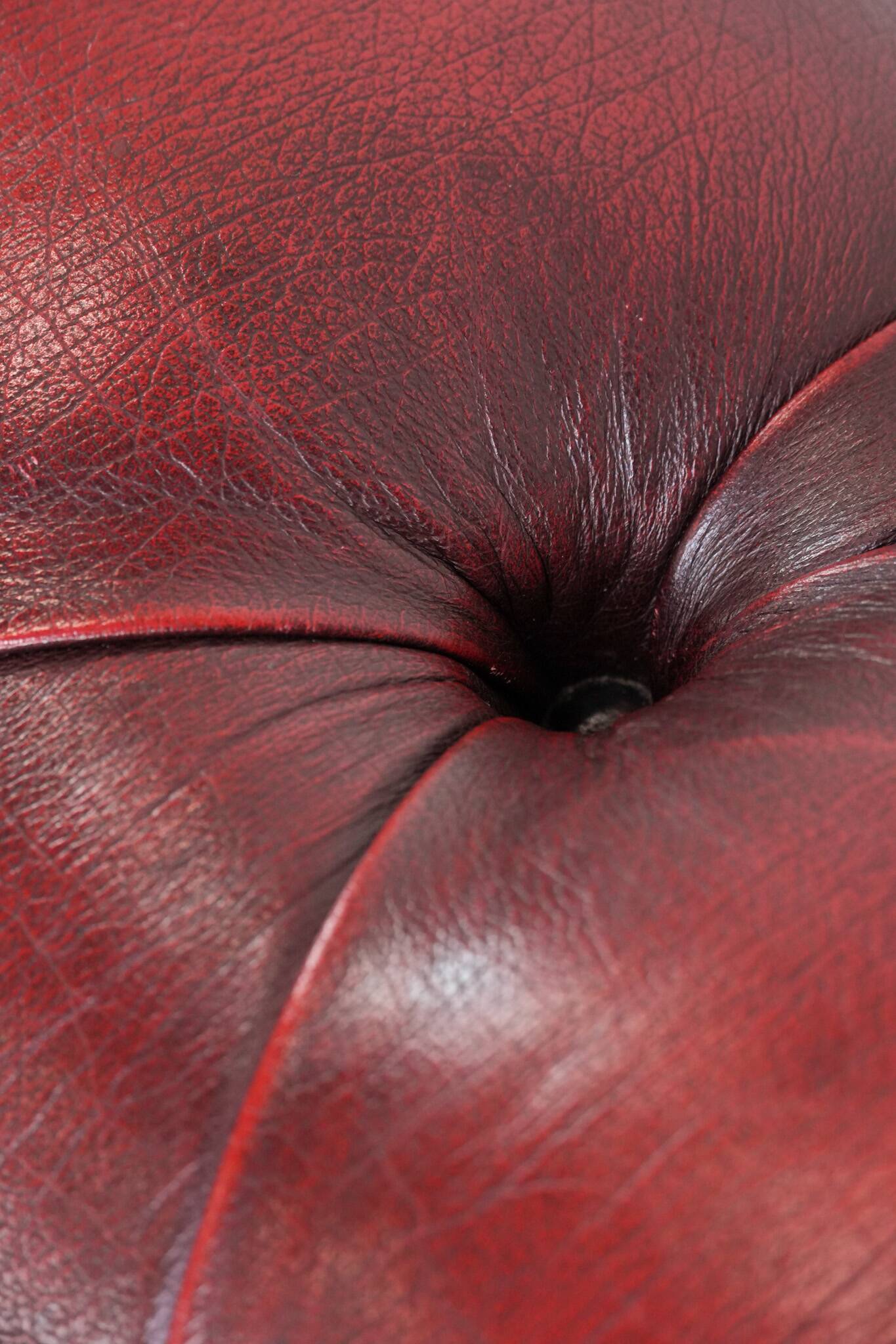 Red English cowhide Chesterfield armchair finished with decorative nails
