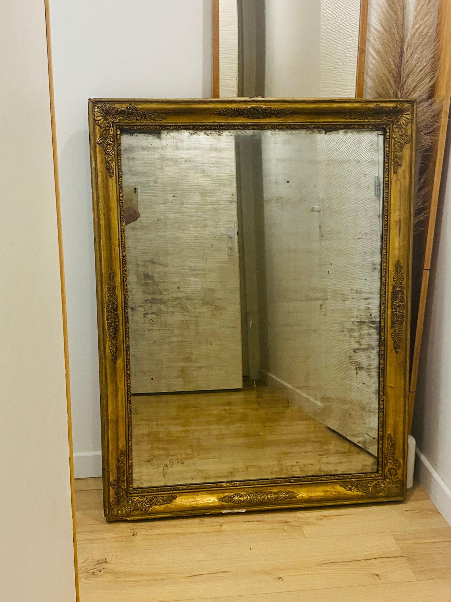 Antique mercury mirror with an Empire gold frame.