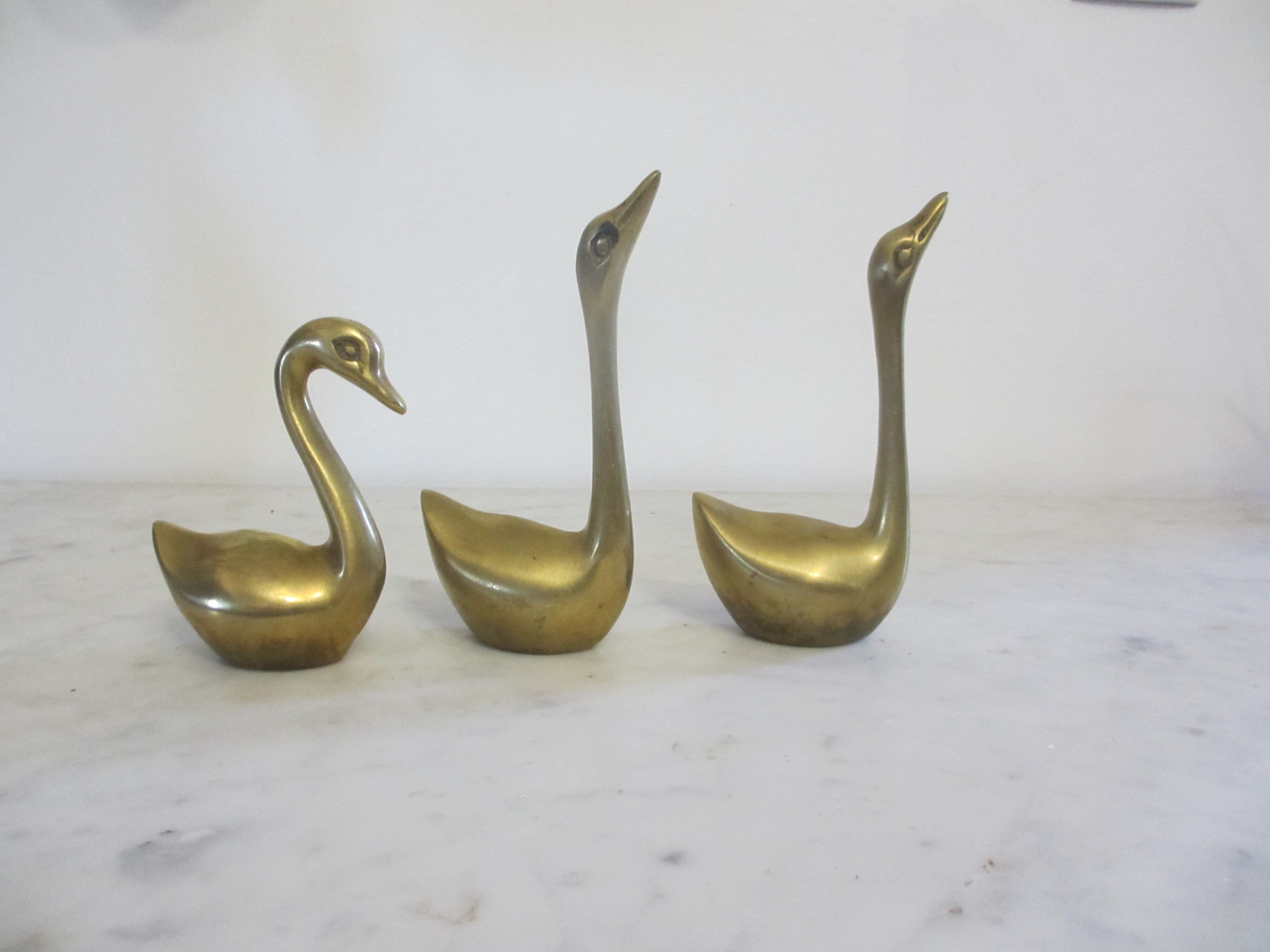 golden brass swans