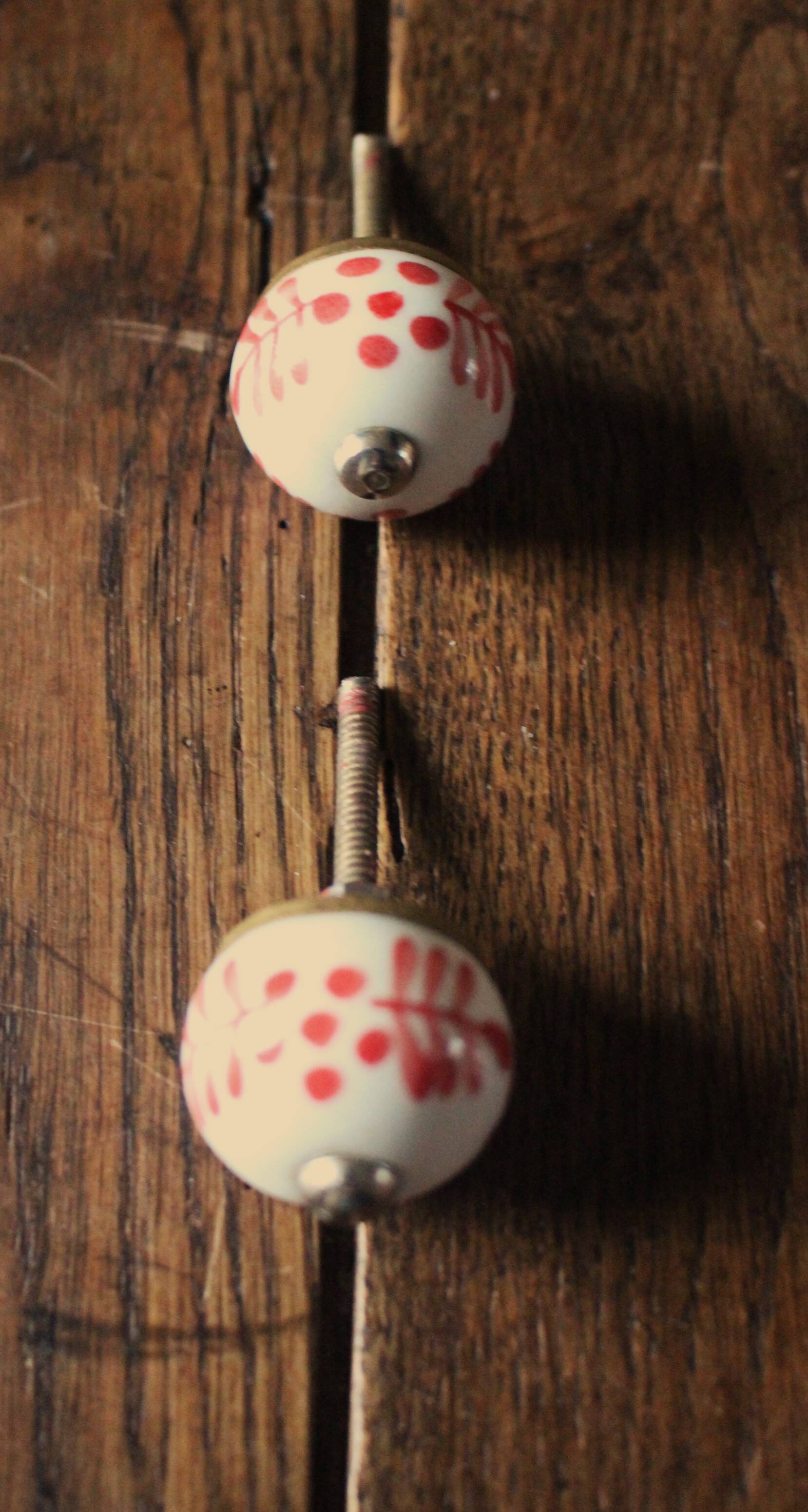 Pair of white and red porcelain drawer cupboard door knobs