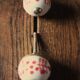 Pair of white and red porcelain drawer cupboard door knobs